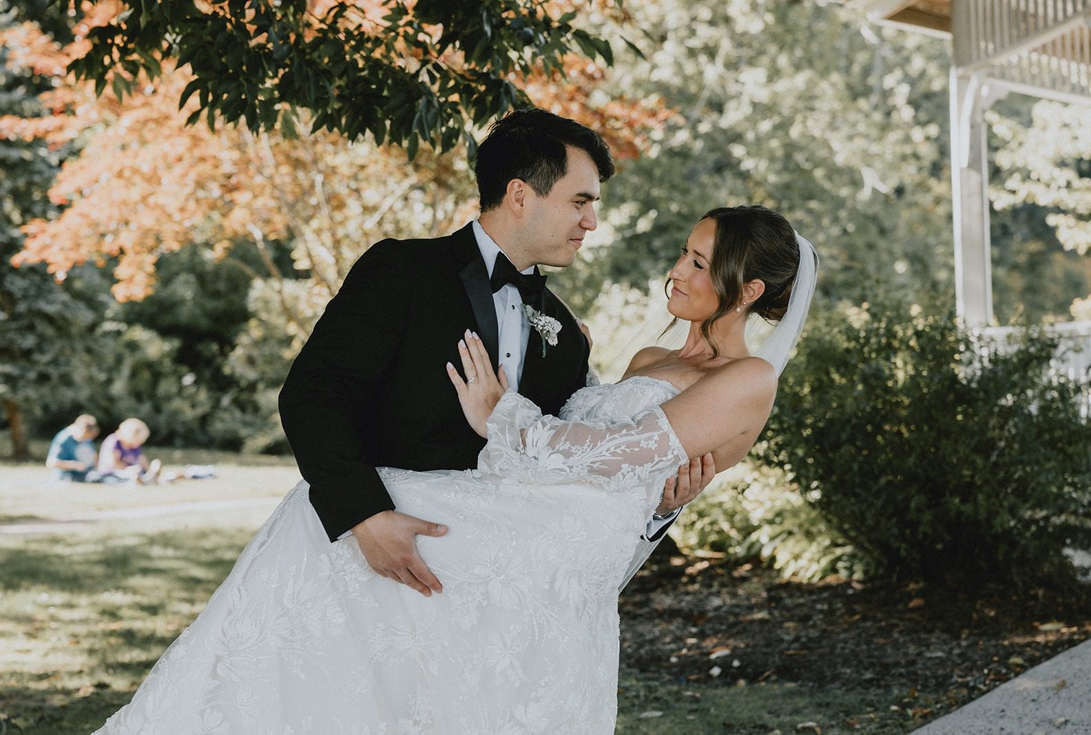 Jacob and Tristan sharing a sweet moment by the gazebo, captured by Hartford wedding photographers from Original Weddings at The Lace Factory