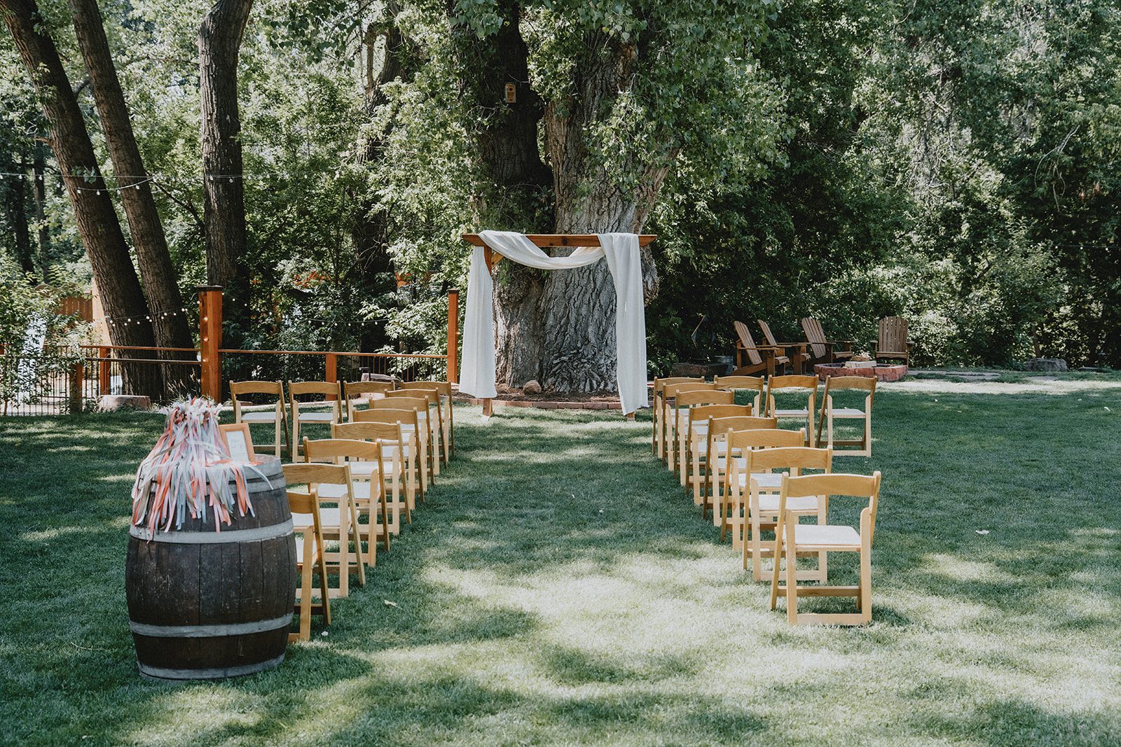 Outdoor ceremony setup under the trees at The Lyons Farmette