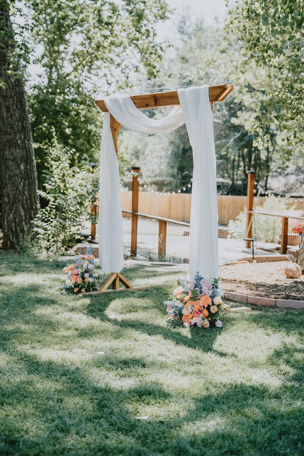 Ceremony arch draped in fabric at The Lyons Farmette