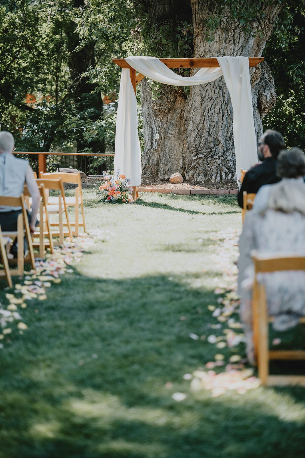 Flower lined aisle leading to the arch at The Lyons Farmette