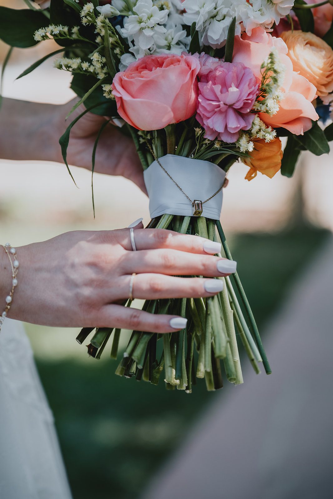 Colorful bridal bouquet with pink and peach flowers