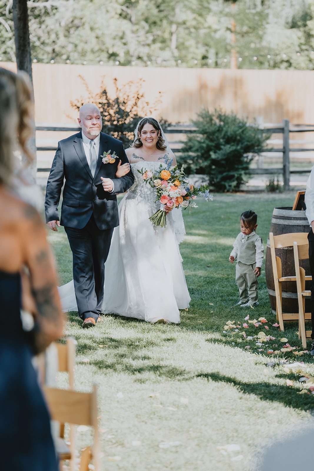 Bride walking down the aisle under the trees