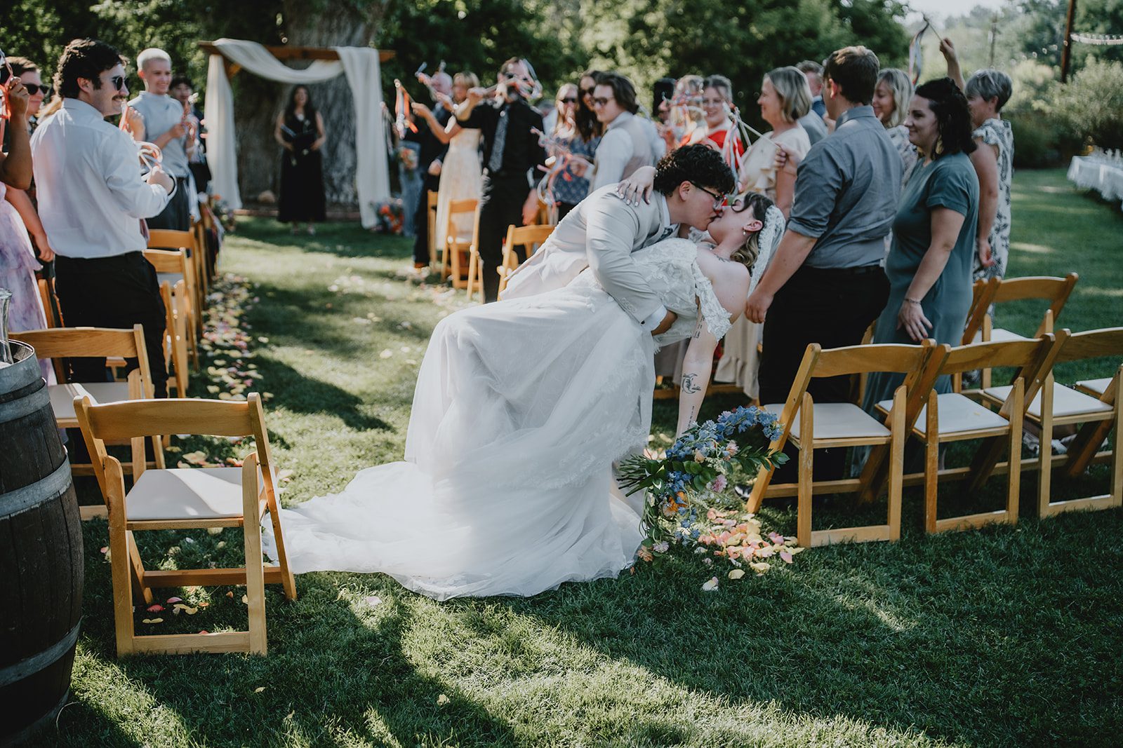 Guests cheering as the couple heads down the aisle
