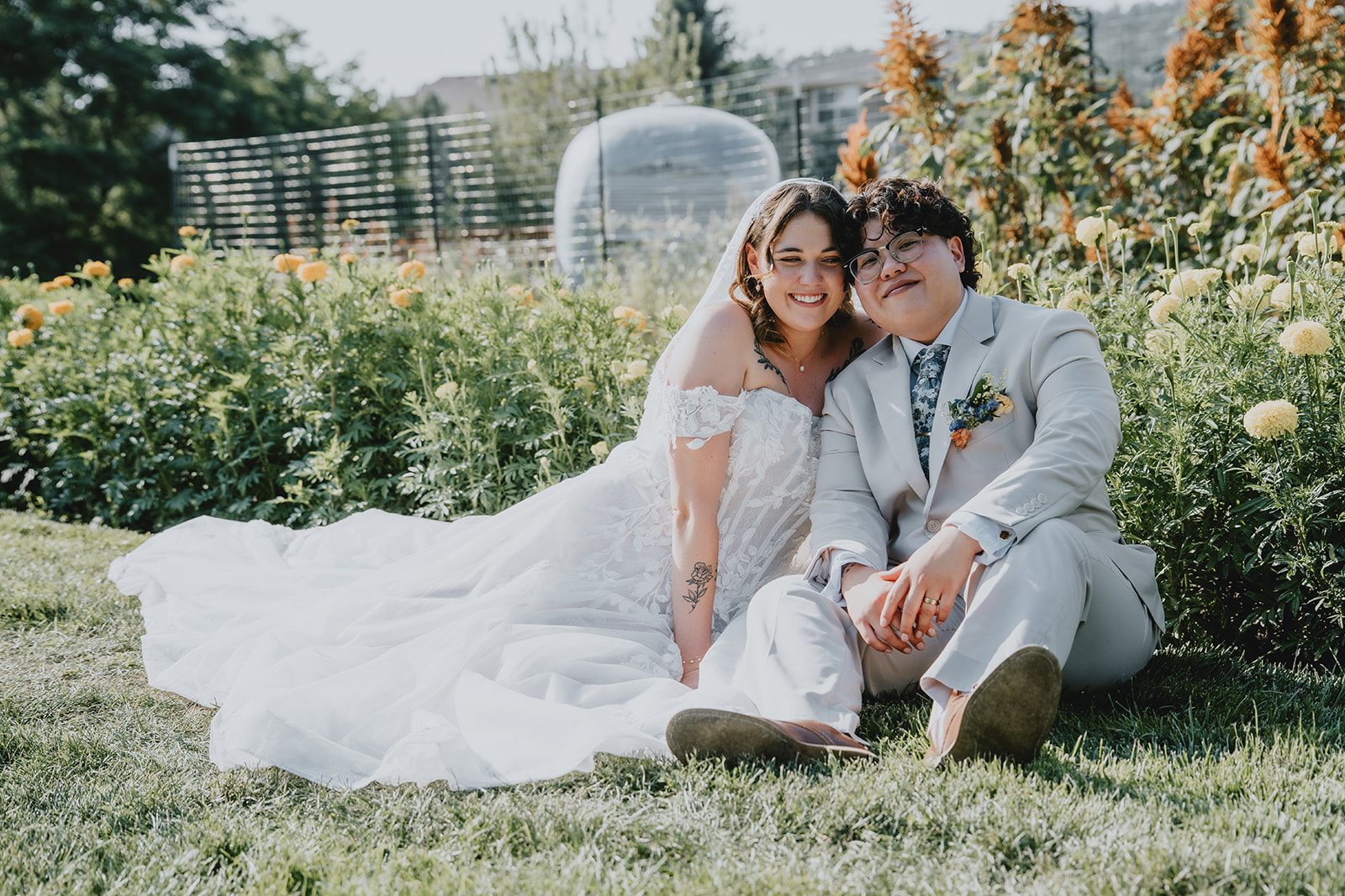Couple sitting together in the flower field, captured by Denver wedding photographers from Original Weddings at The Lyons Farmette