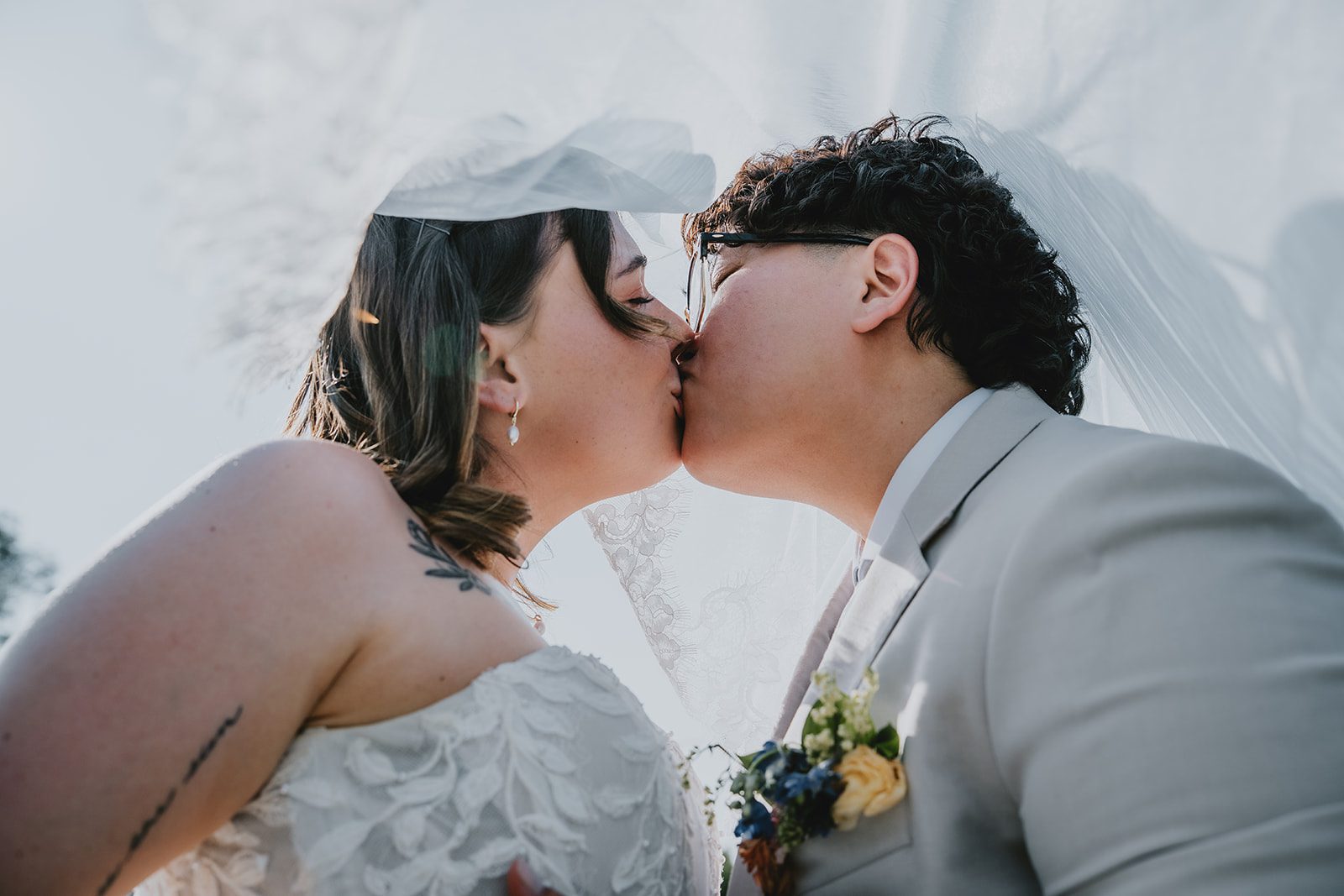 Newlyweds sharing a close kiss