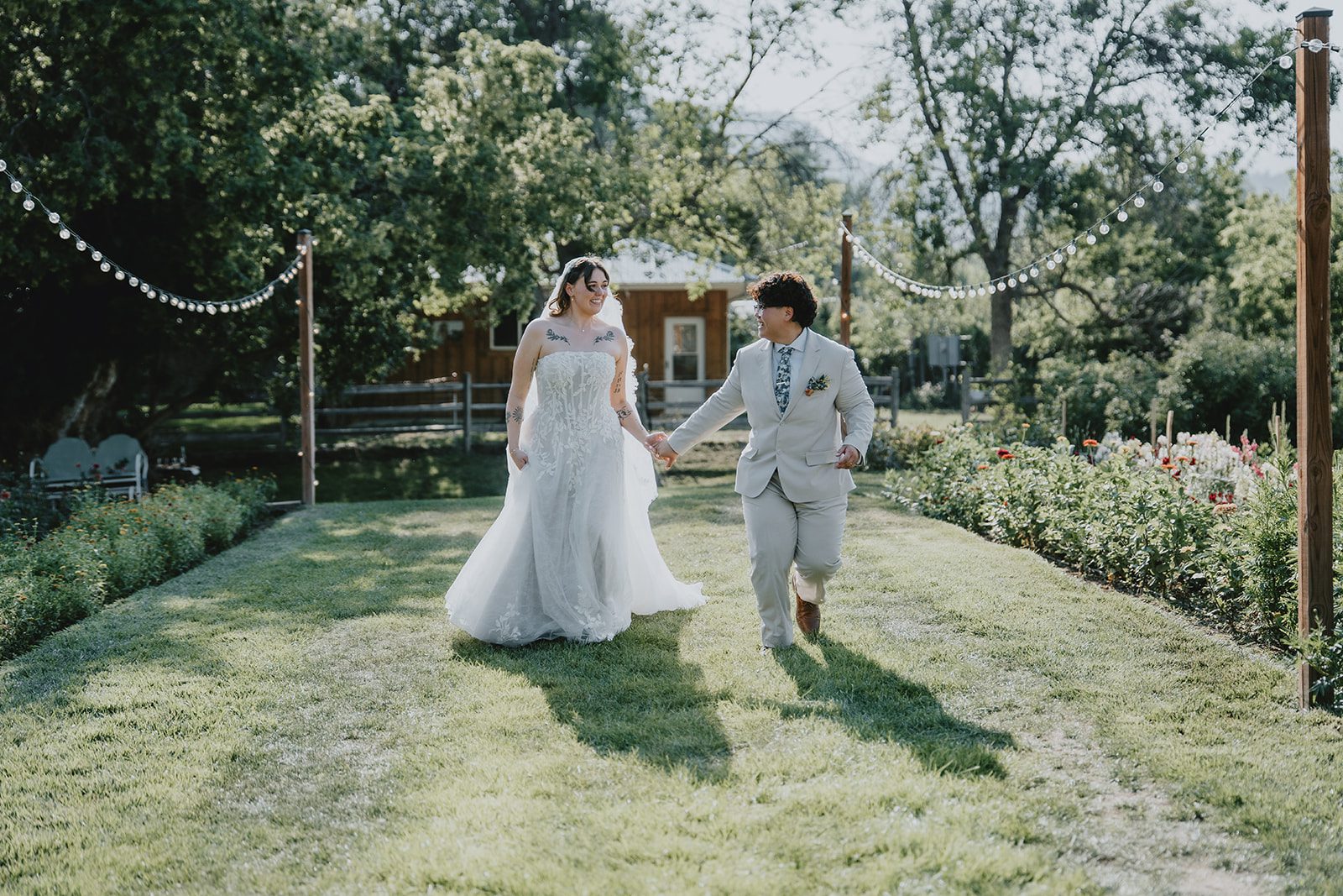 Couple walking hand in hand across the lawn
