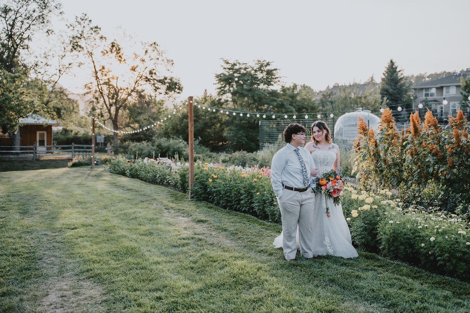 Couple in the field at golden hour at The Lyons Farmette
