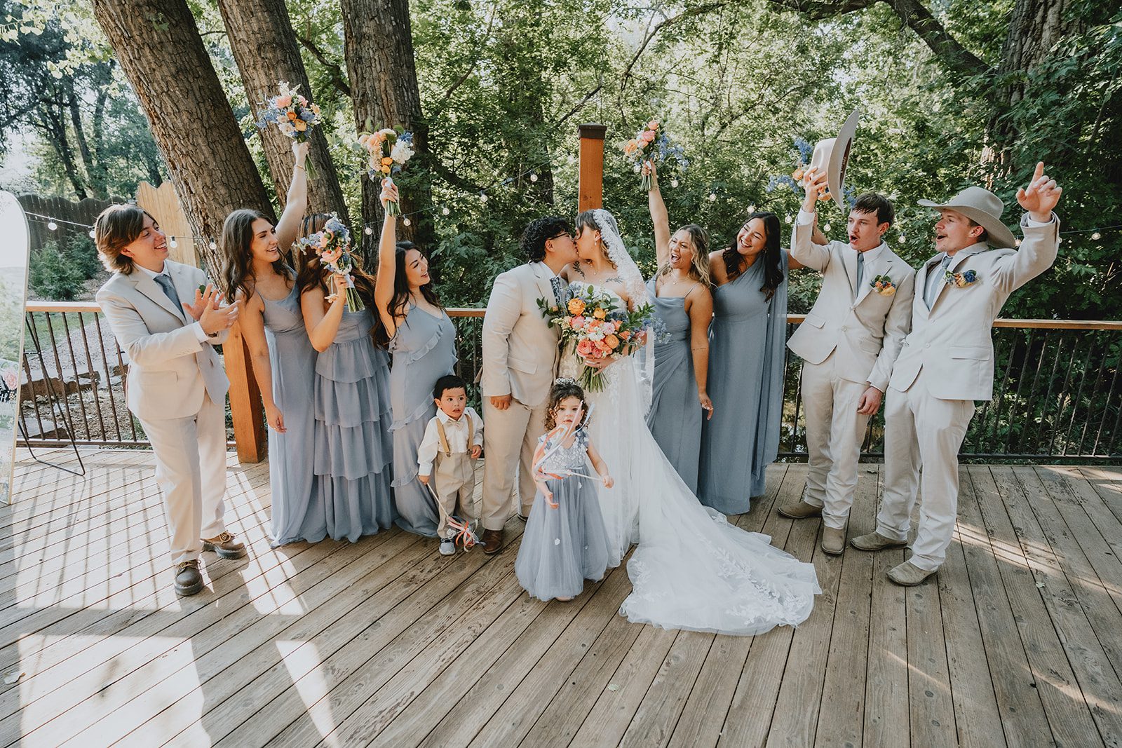 Wedding party cheering for the newlyweds