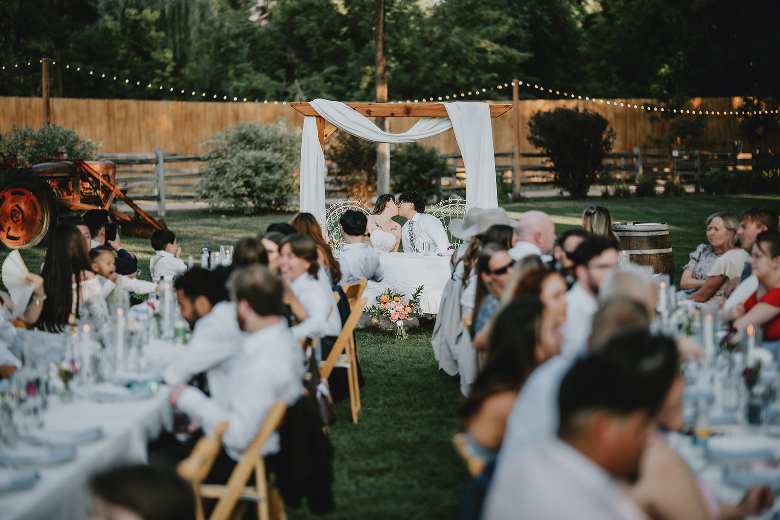 Guests enjoying dinner at the long tables