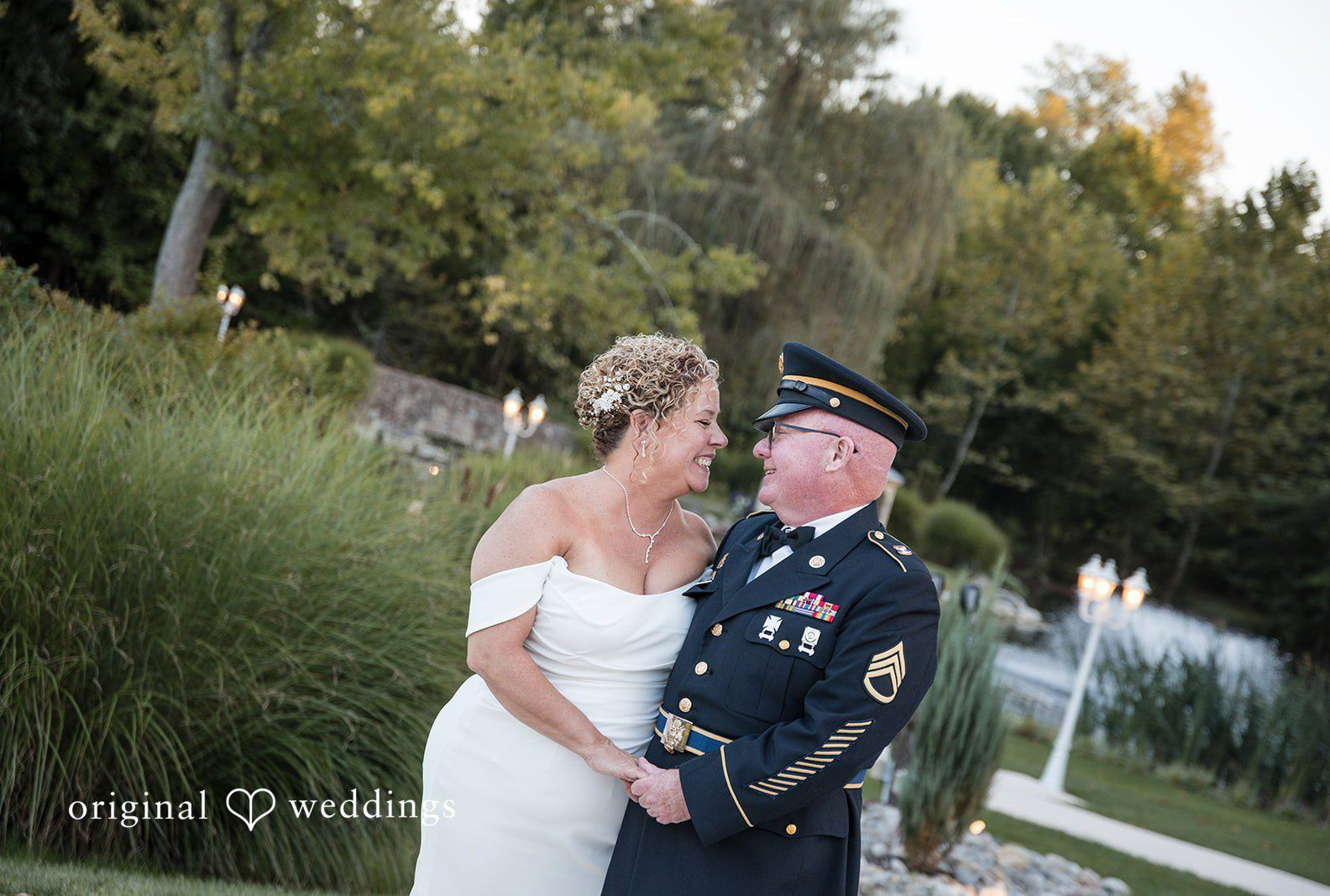 Lynette and Bryan smiling at each other in the garden, captured by Philadelphia wedding photographers from Original Weddings at The Manor House at Prophecy Creek