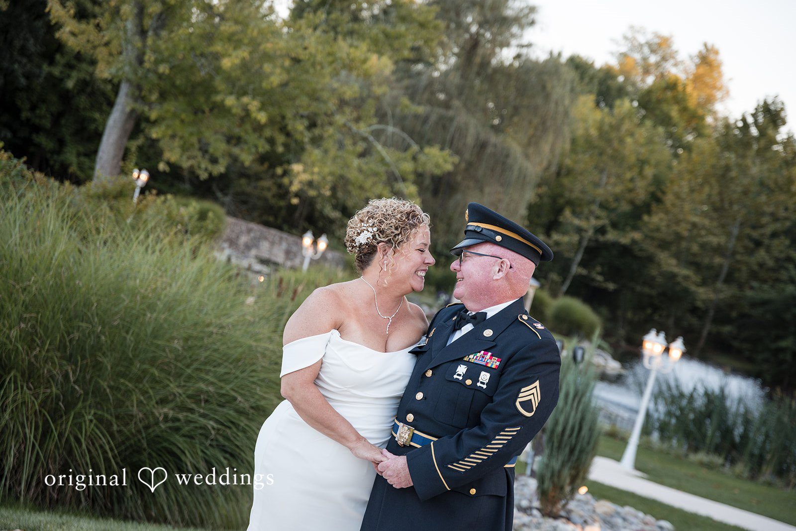 Bryan + Lynette Lynette and Bryan smiling at each other in the garden, captured by Philadelphia wedding photographers from Original Weddings at The Manor House at Prophecy Creek