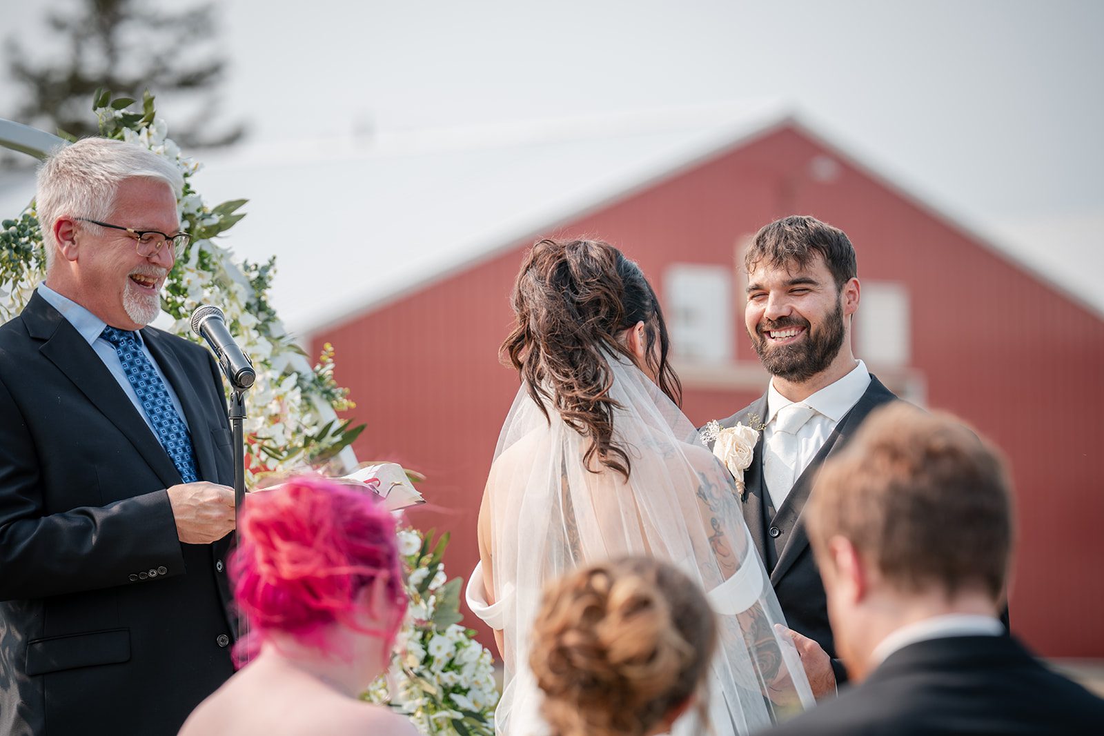 the-midway-timeless-minneapolis-sarah-drew-p020-41 Officiant leading the ceremony by the red barn