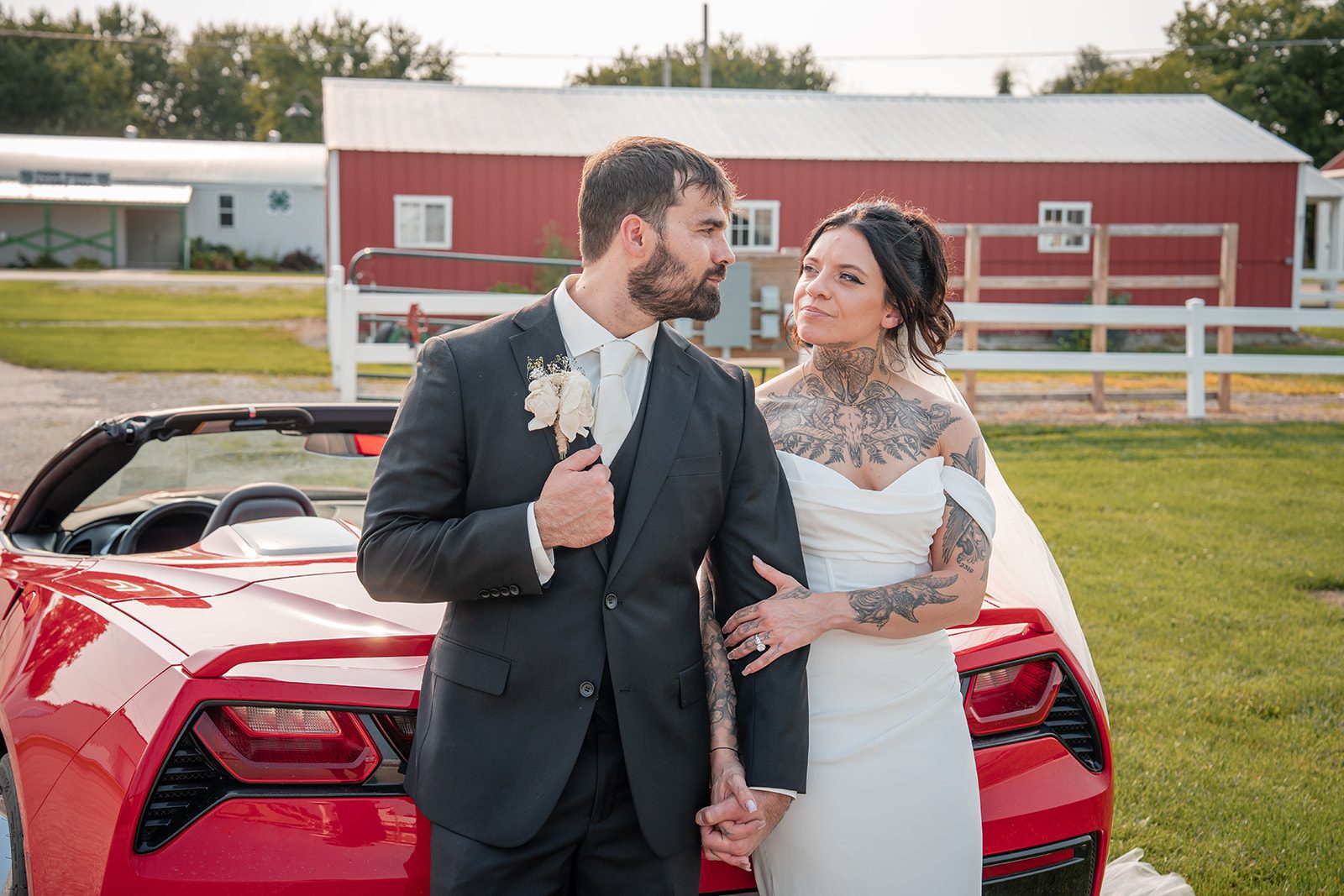 the-midway-timeless-minneapolis-sarah-drew-p025-11 Bride and groom posing with a red sports car at The Midway