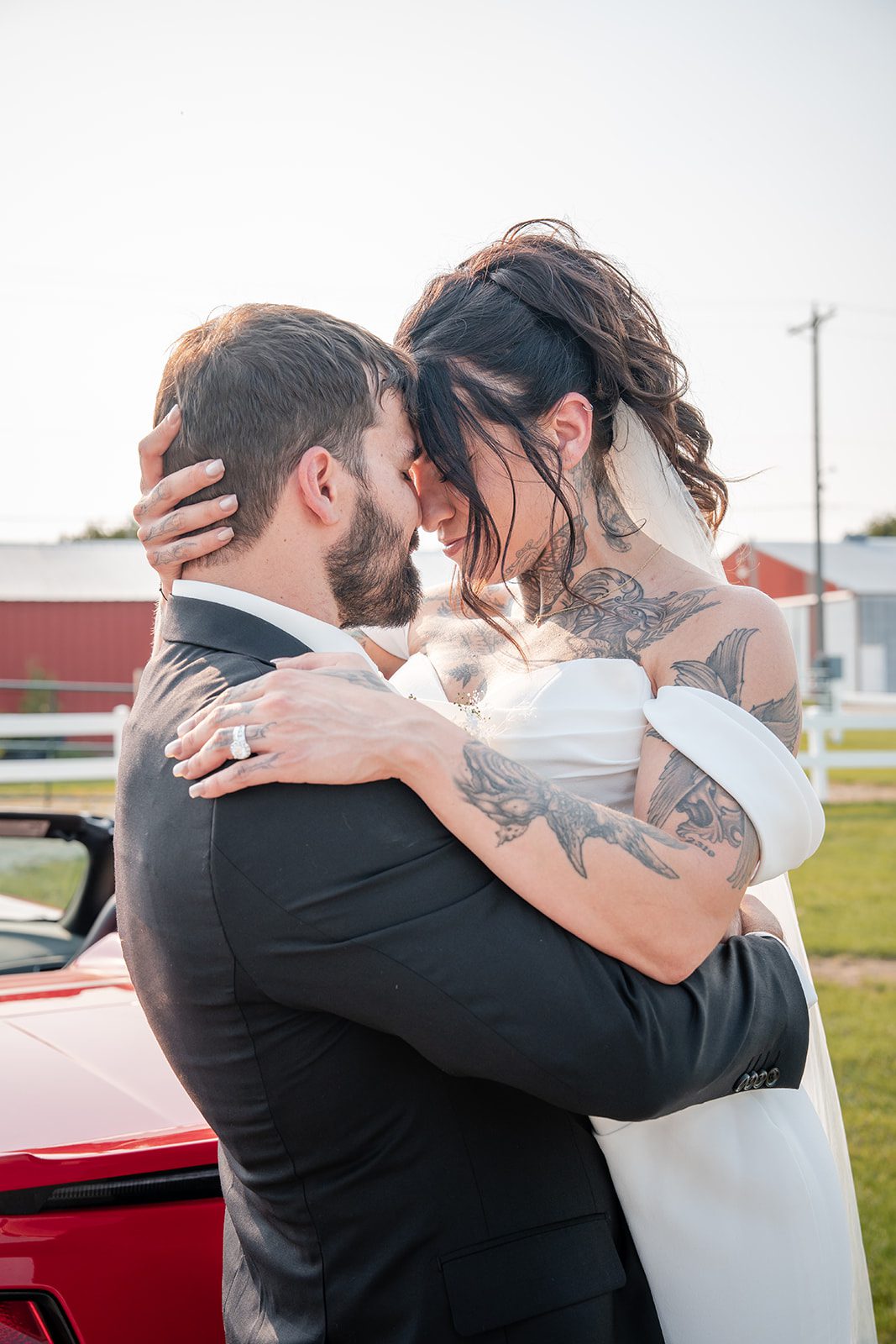 the-midway-timeless-minneapolis-sarah-drew-p028-29 Couple embracing beside the red car
