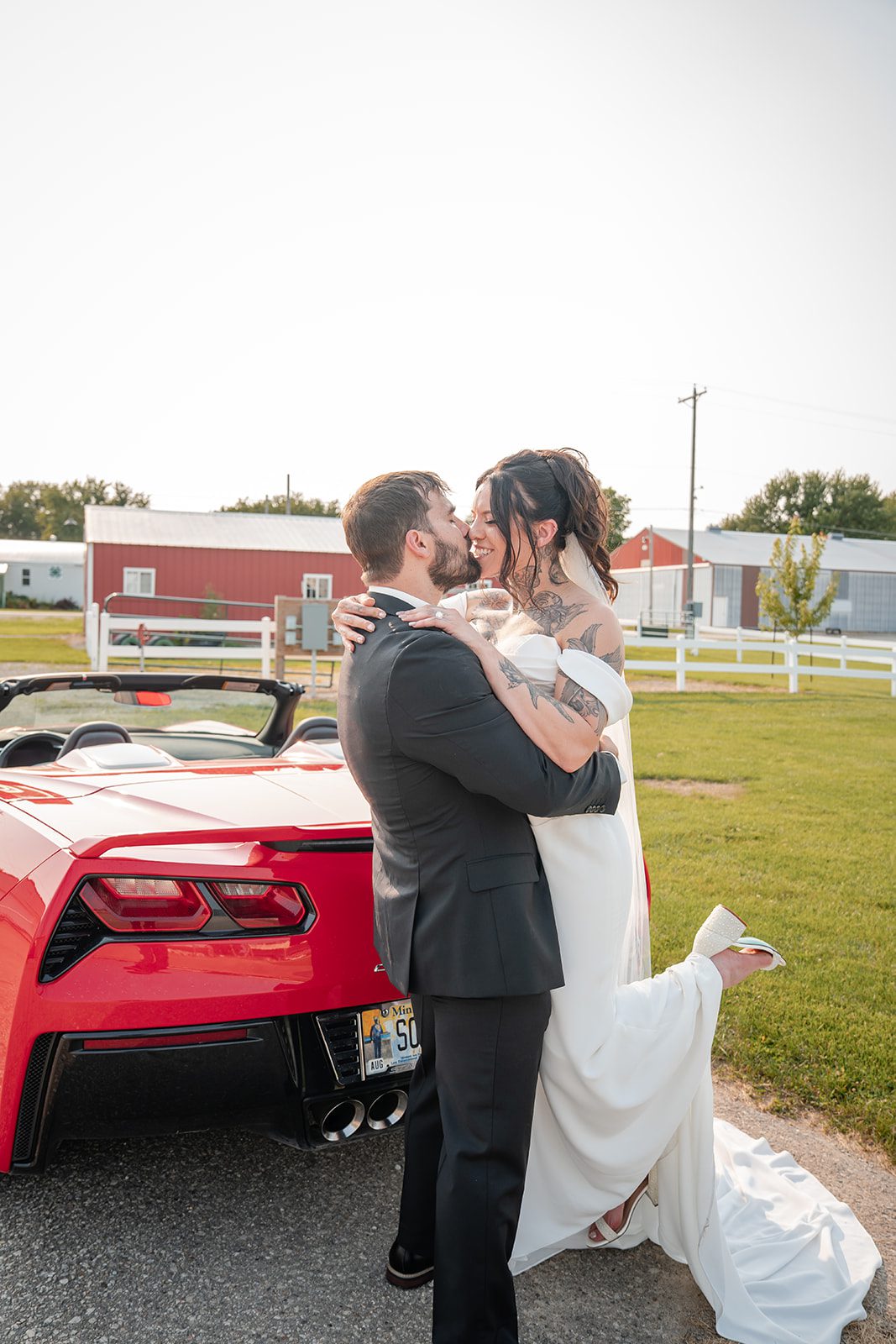 the-midway-timeless-minneapolis-sarah-drew-p029-39 Newlyweds walking by the sports car