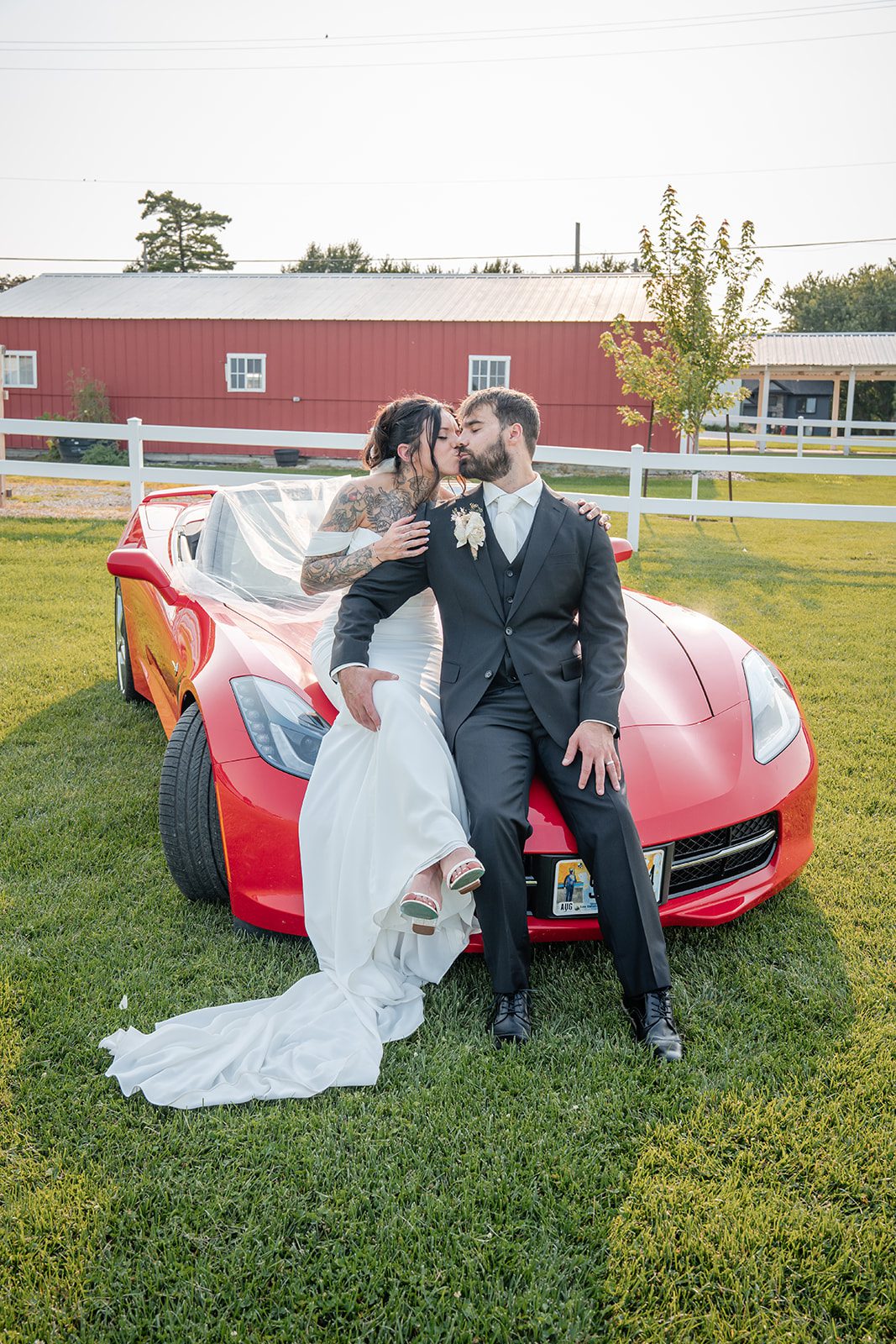 the-midway-timeless-minneapolis-sarah-drew-p031-32 Bride and groom leaning on the red car