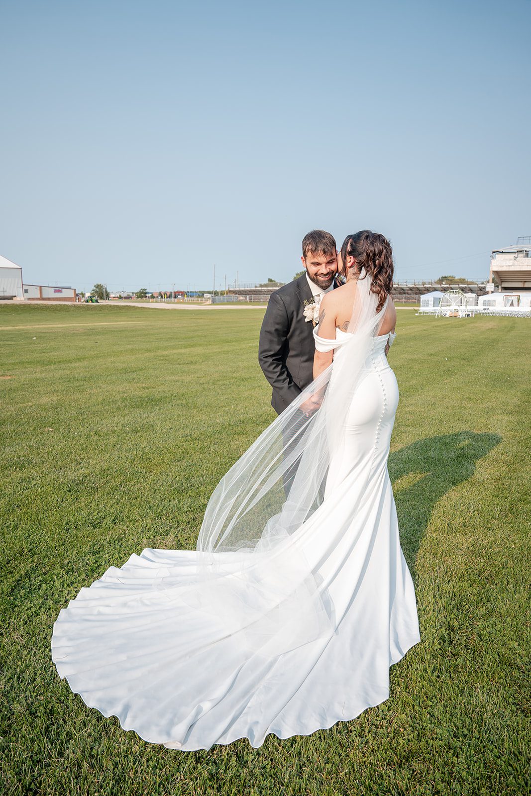 the-midway-timeless-minneapolis-sarah-drew-p032-07 Couple sharing a kiss in the field at The Midway