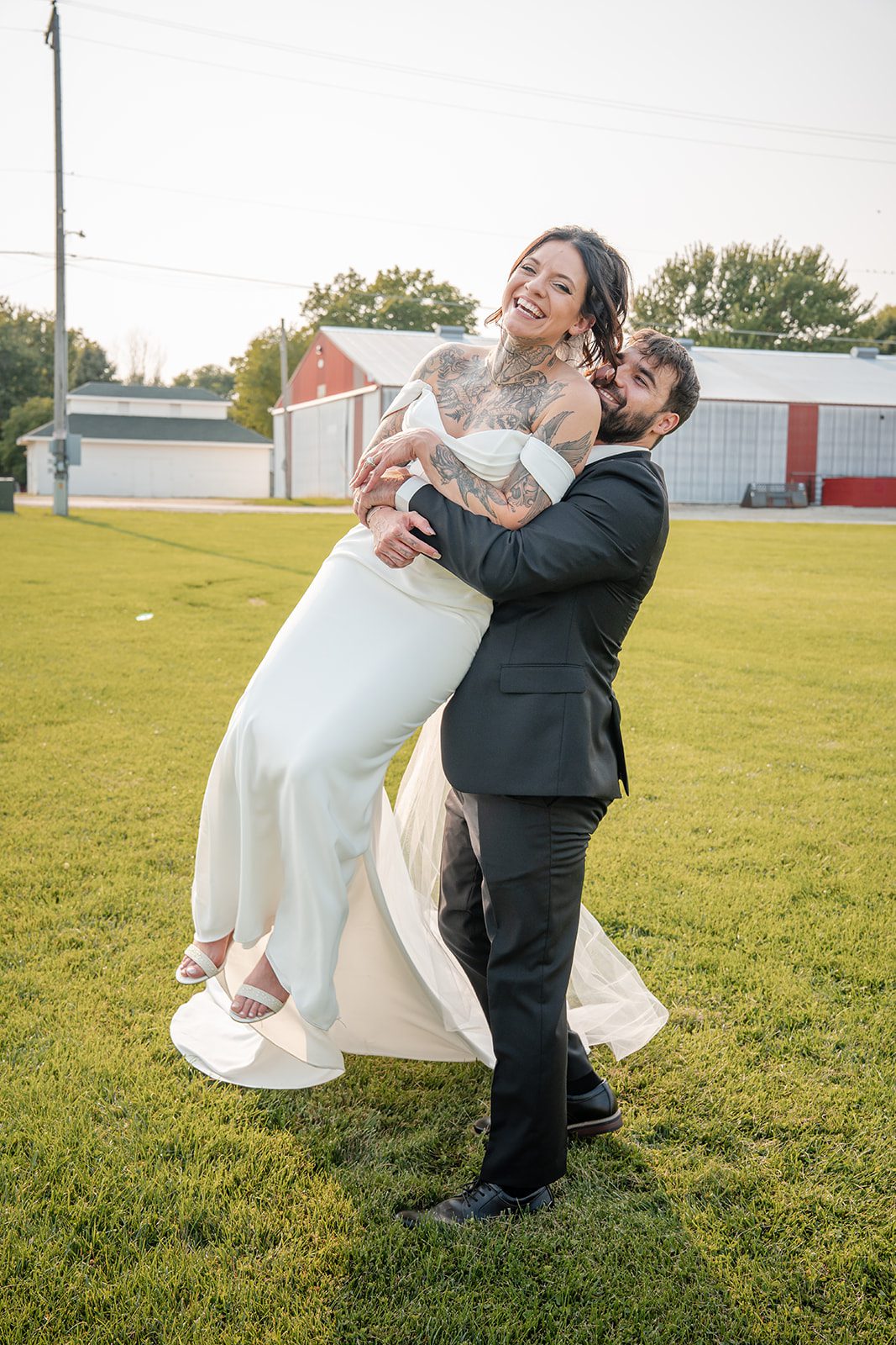 the-midway-timeless-minneapolis-sarah-drew-p033-20 Groom lifting the bride in the open field