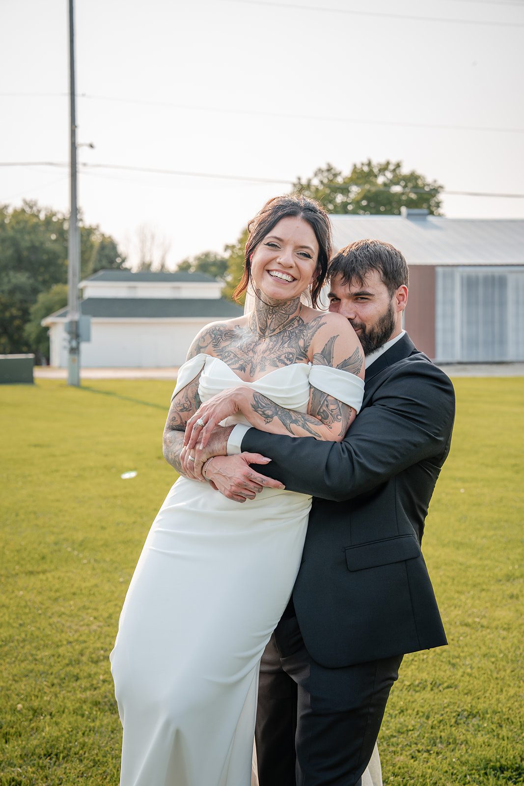 the-midway-timeless-minneapolis-sarah-drew-p034-21 Bride and groom laughing together on the lawn