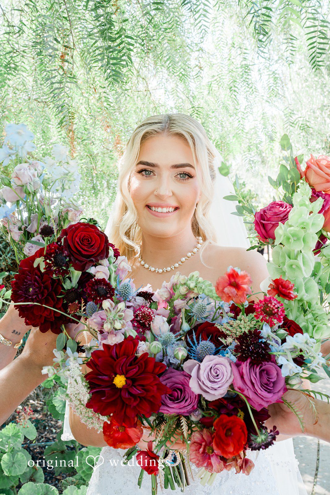 Savannah + Lucas Bride holding her red and pink bouquet