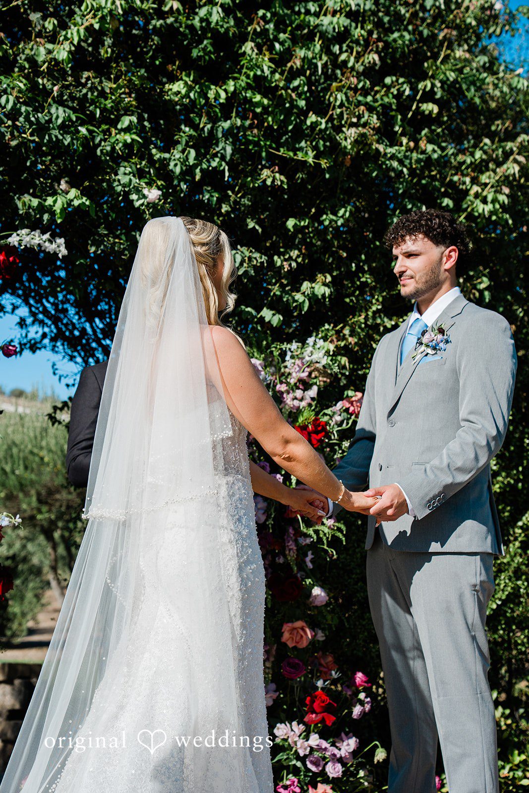 Savannah + Lucas Couple holding hands during their vows