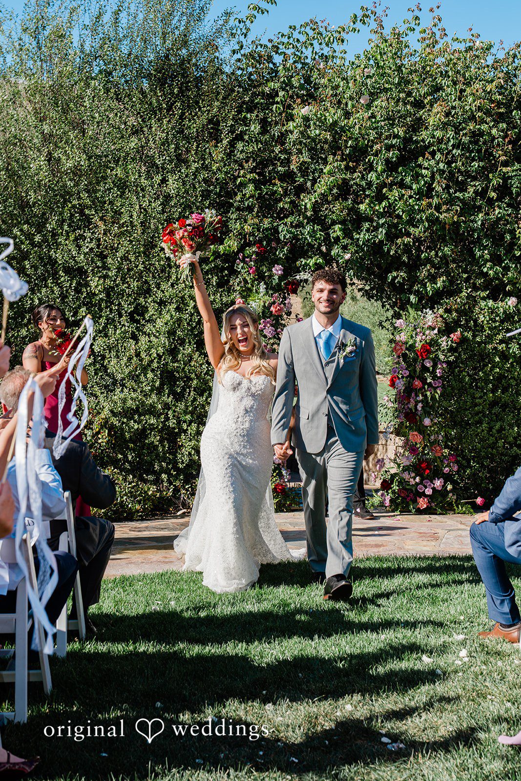Savannah + Lucas Couple raising their hands on the recessional