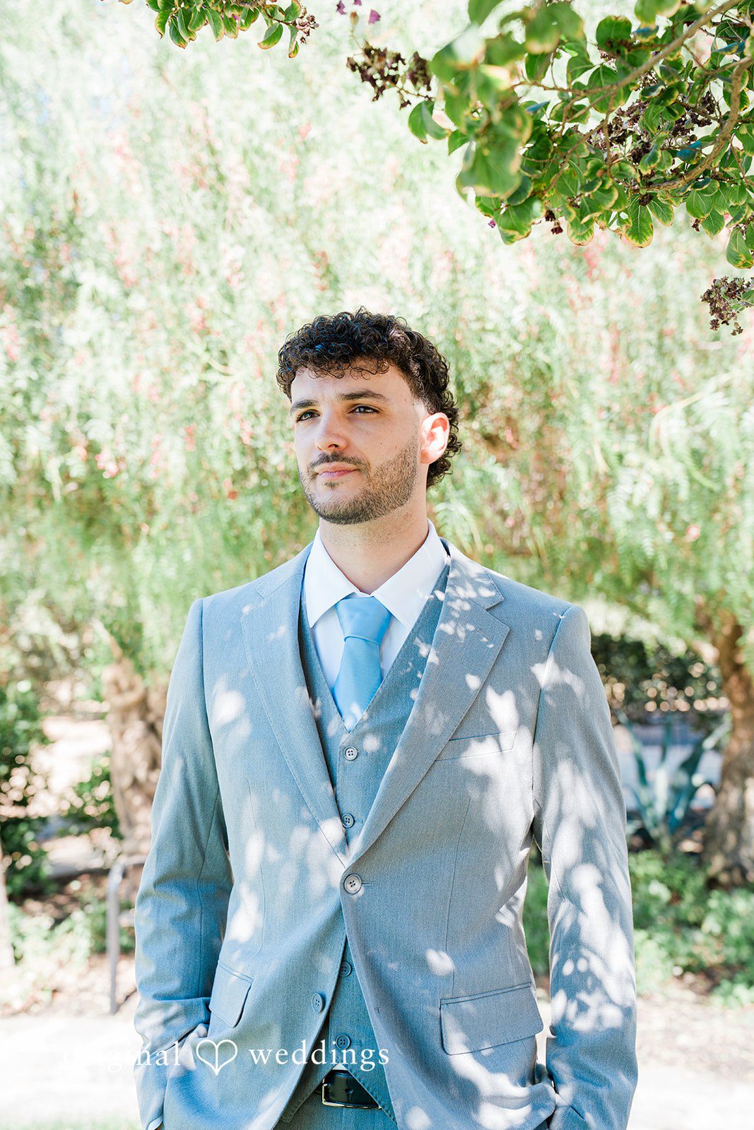 Savannah + Lucas Groom smiling in his light gray suit