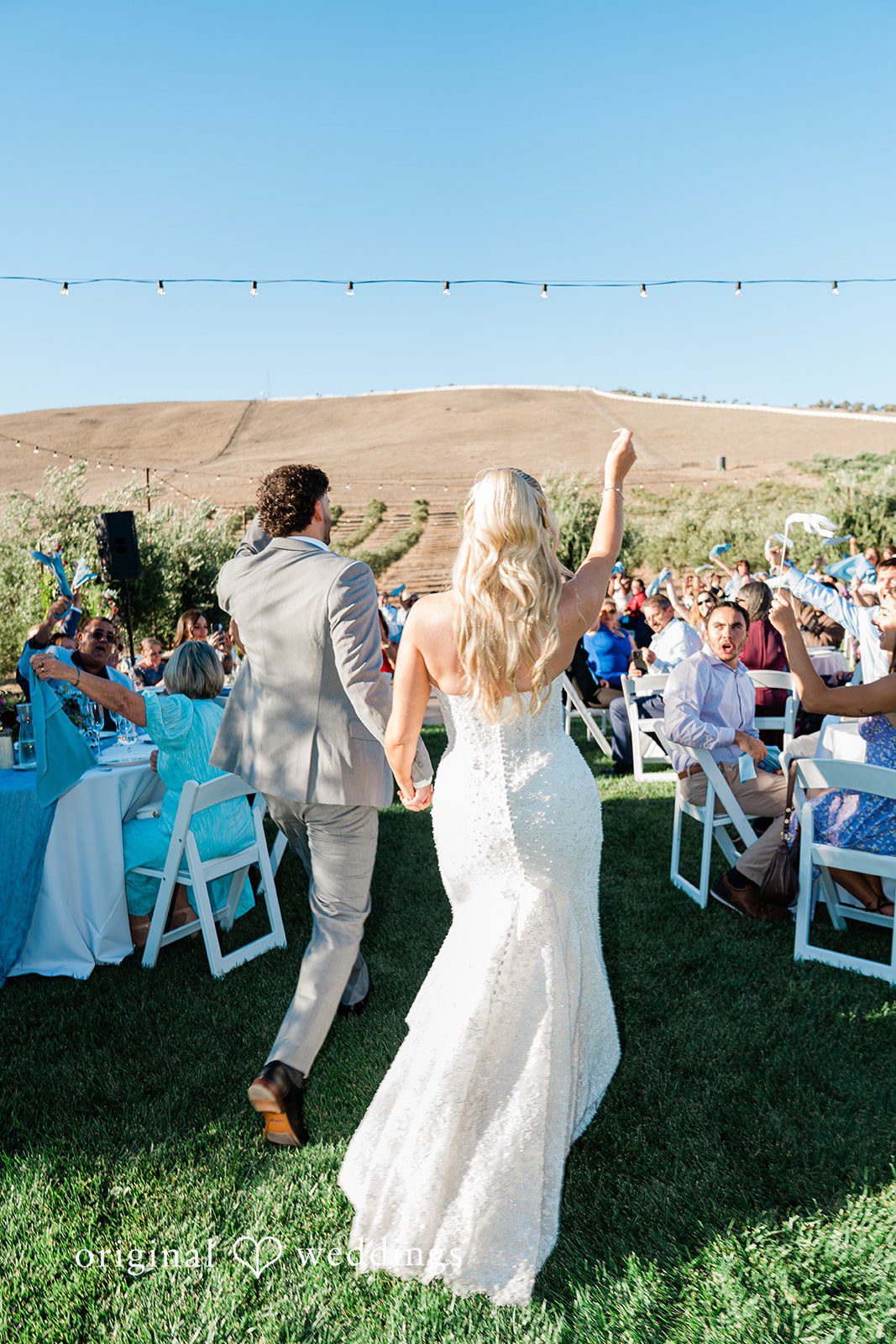 Savannah + Lucas Newlyweds cheering as they walk back up the aisle