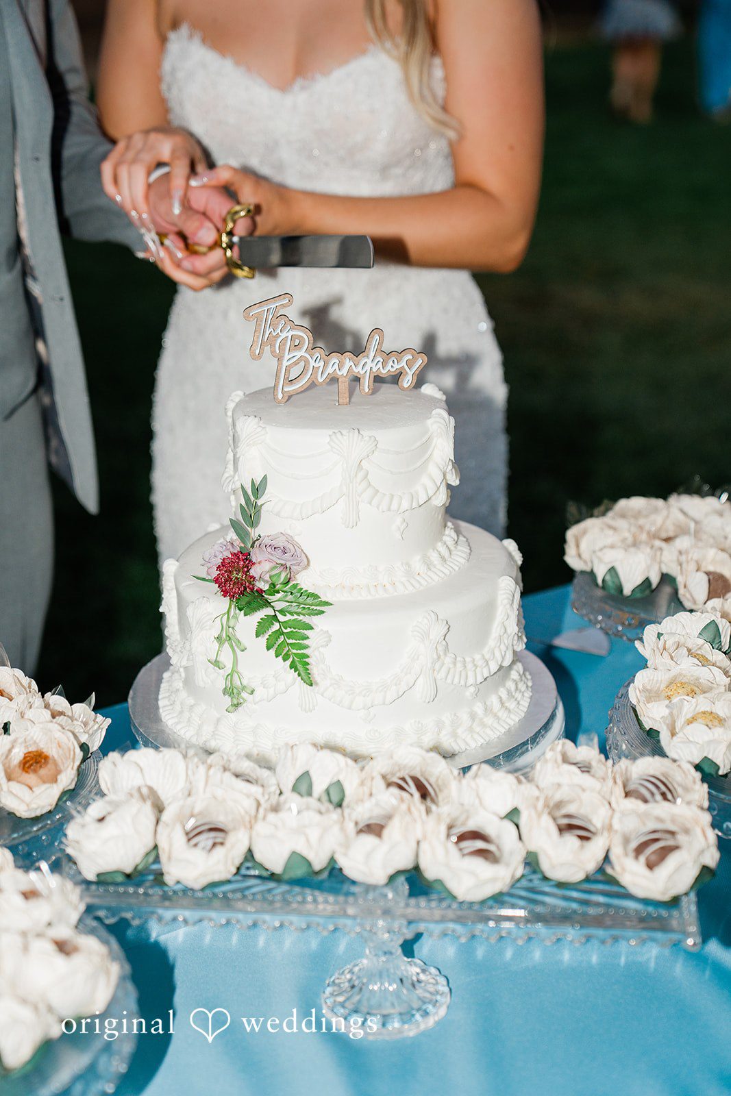 Savannah + Lucas White wedding cake surrounded by florals