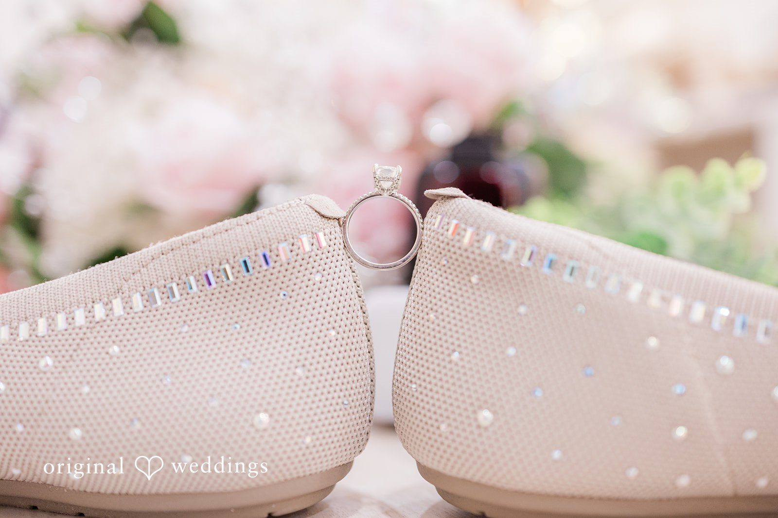 Daniel + Dalte A close-up view of the heels of two glittering bridal shoes.