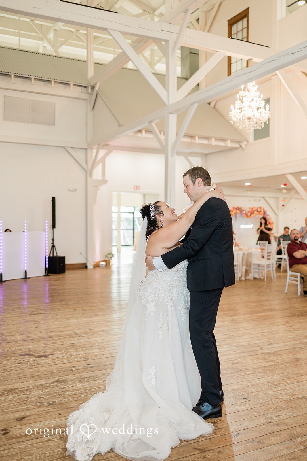 Daniel + Dalte A bride and groom holding each other closely during a reception dance.