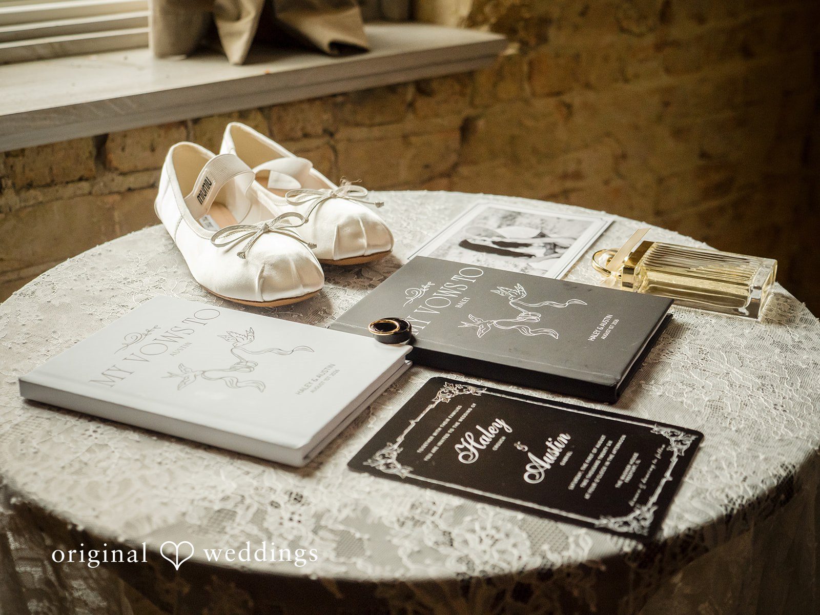Haley + Austin White bridal shoes placed next to matching luxury wedding invitations and flat-lay details.