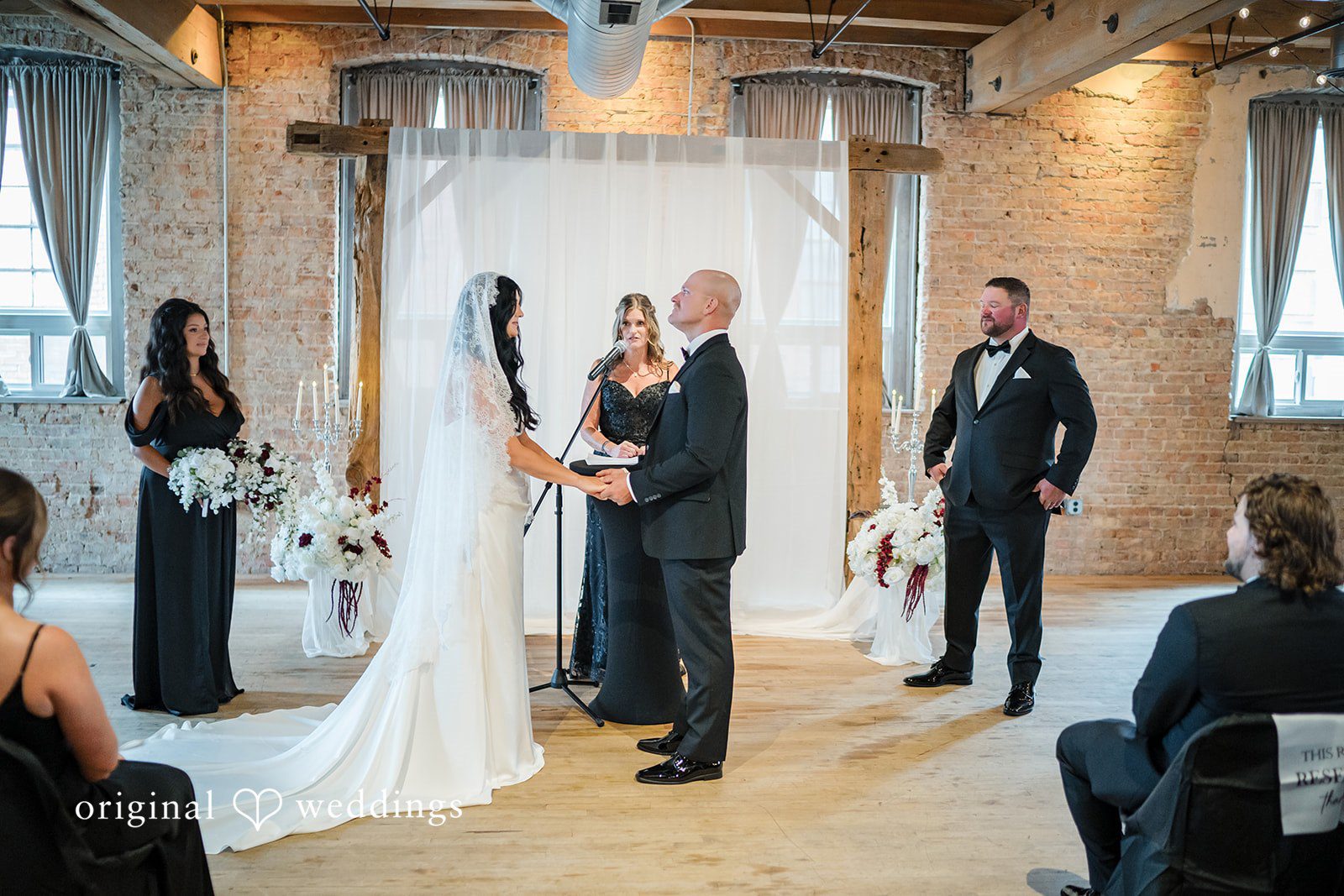 August 01, 2026 – Haley & Austin – (ID-4892) A bride and groom holding hands while facing each other at the altar during their ceremony.