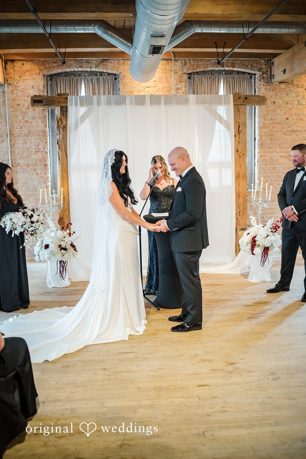 August 01, 2026 – Haley & Austin – (ID-4892) A bride and groom exchanging vows in front of an officiant.