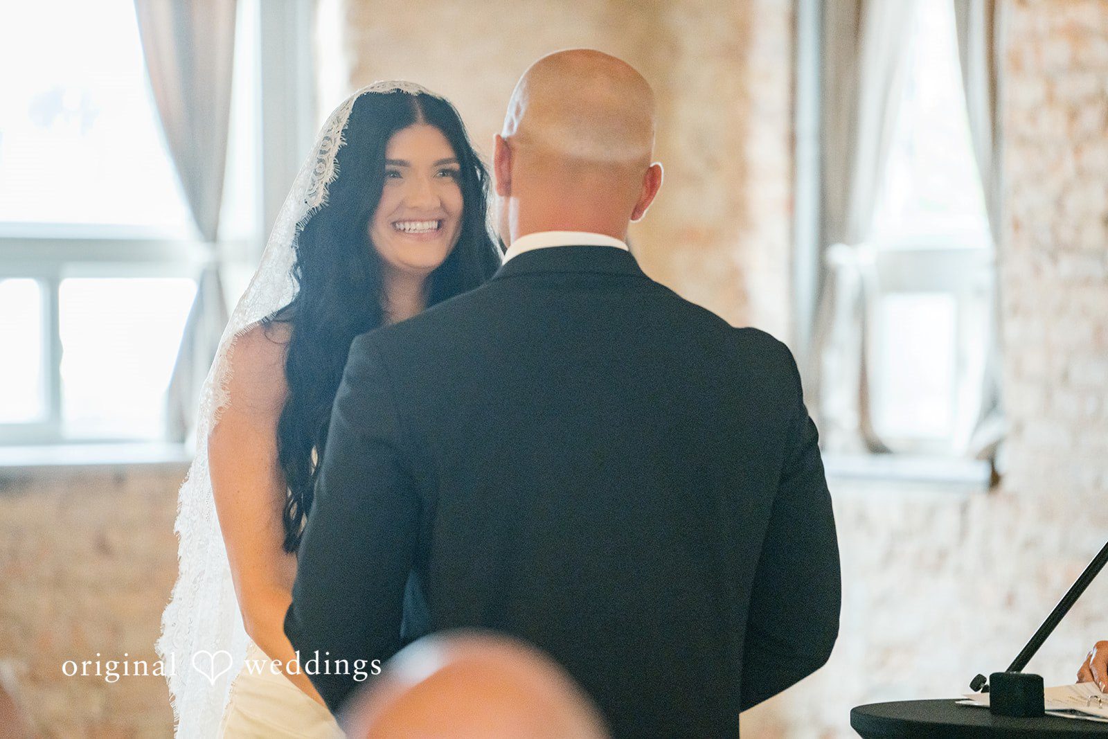 August 01, 2026 – Haley & Austin – (ID-4892) A bride facing a groom seen from behind during a ceremony moment.