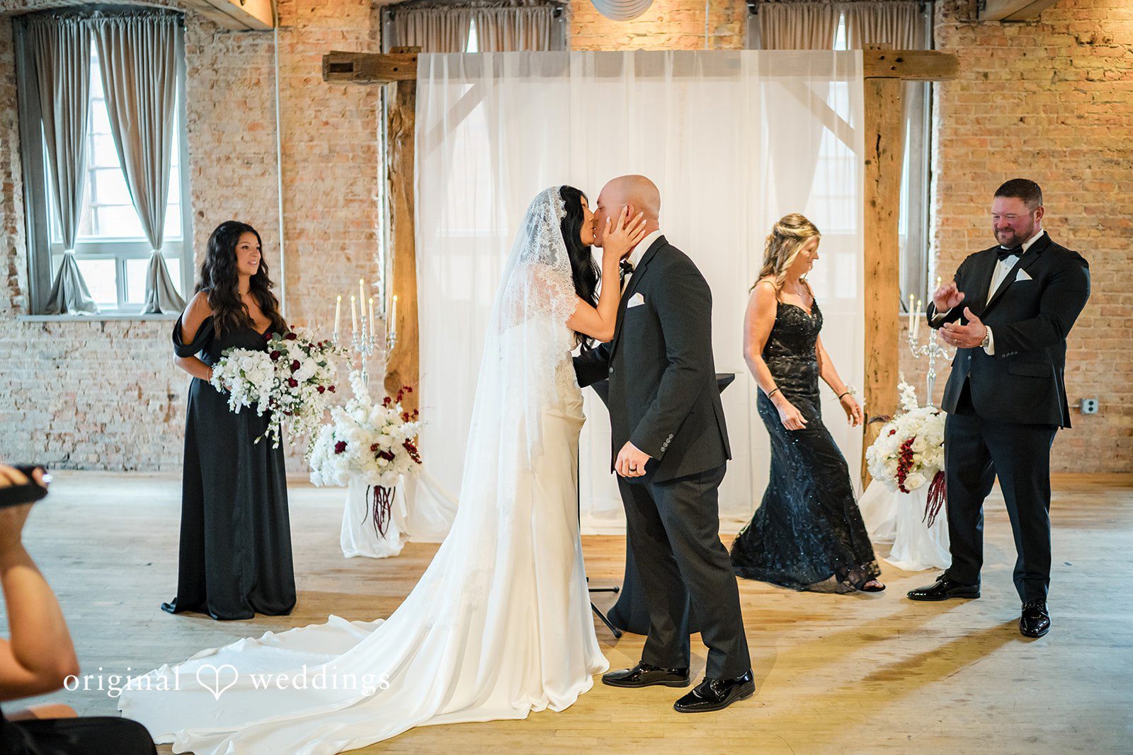 August 01, 2026 – Haley & Austin – (ID-4892) A bride and groom standing together at the altar surrounded by their wedding party.