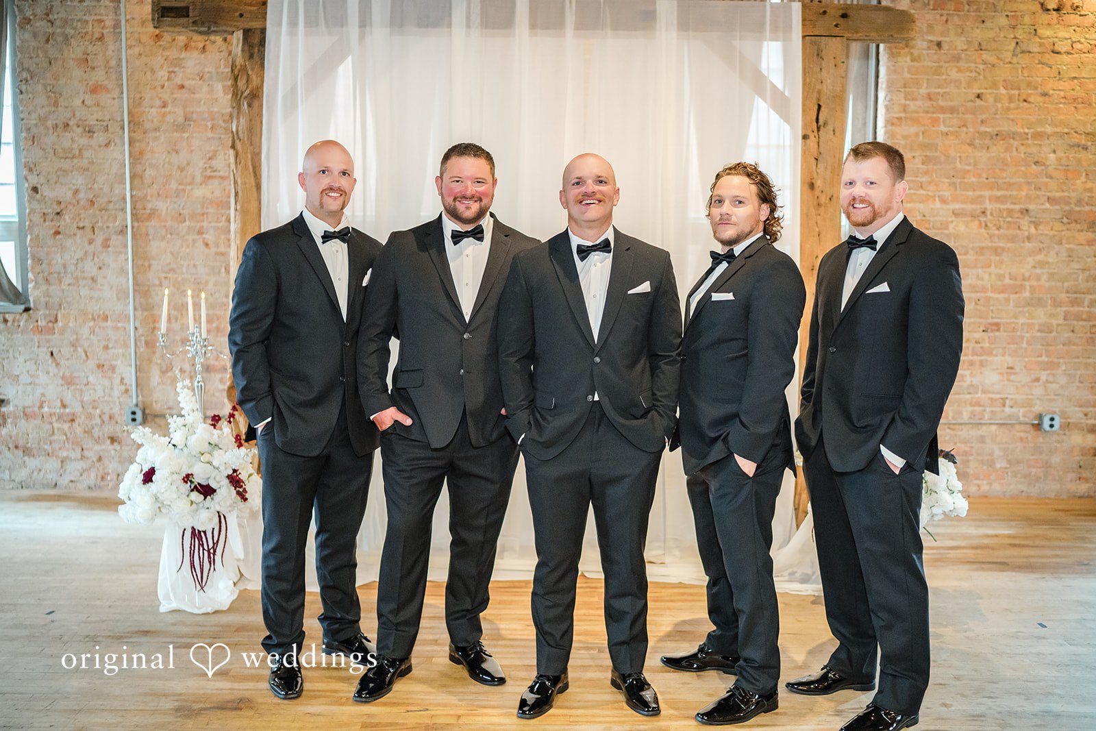 August 01, 2026 – Haley & Austin – (ID-4892) A groom standing together with his groomsmen all dressed in sharp black tuxedos.