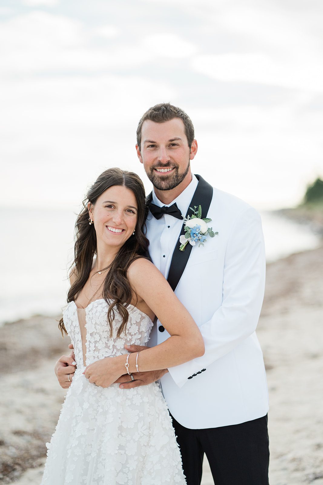 the-wharf-airy-boston-lia-cam-026-40 Bride and groom smiling together on the beach, captured by Boston wedding photographers from Original Weddings at The Wharf