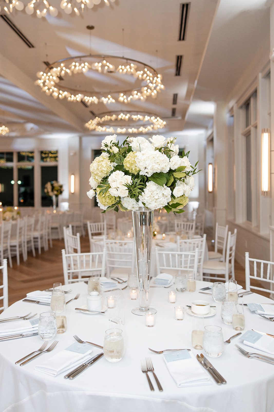 Tall white centerpieces on the reception tables