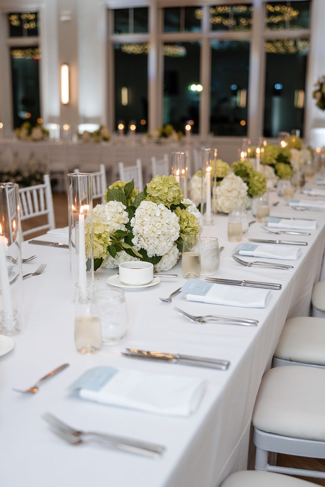 Long tables with candles and white flowers