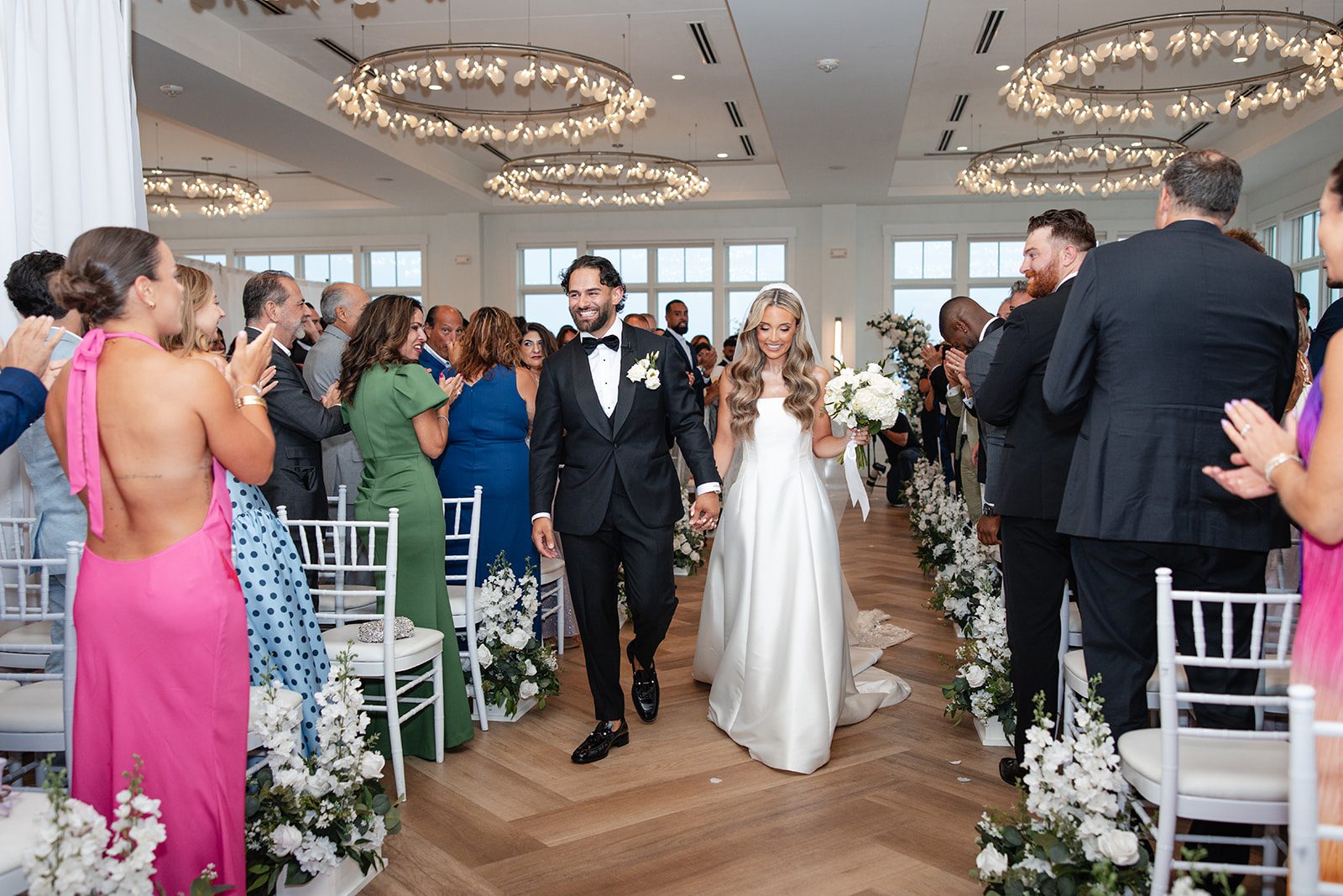 Newlyweds celebrating down the aisle