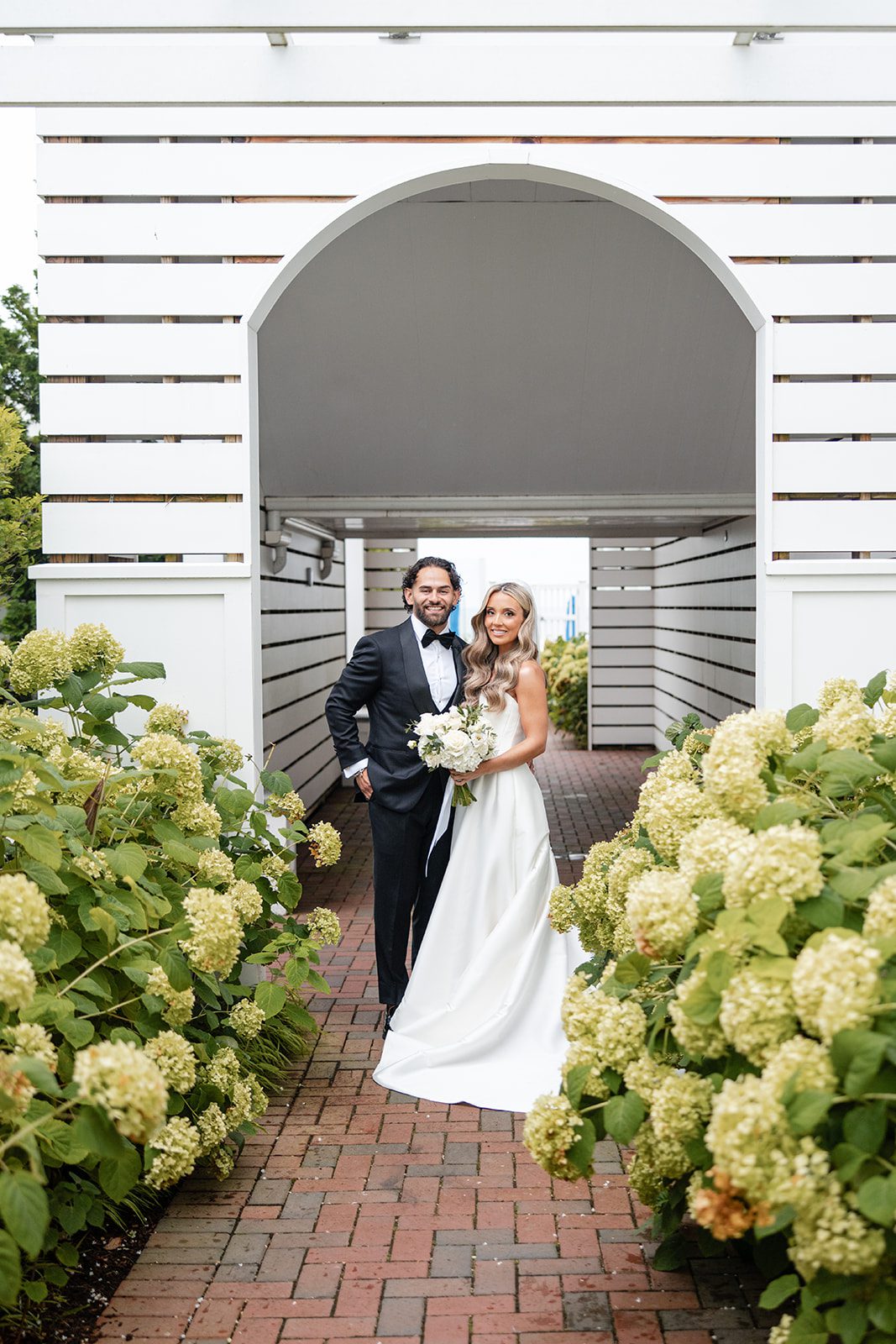 Couple under the white arbor