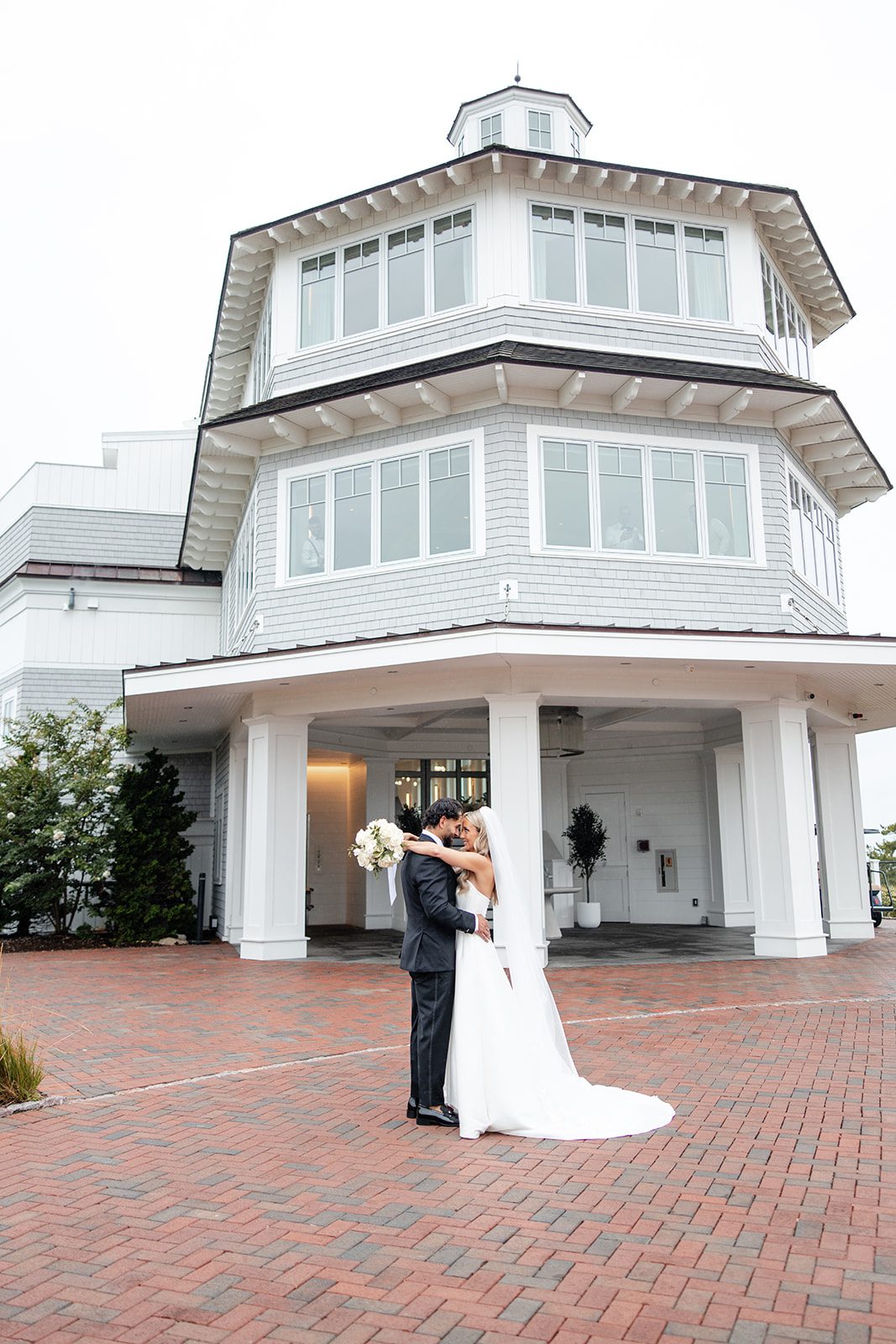 Bride and groom in front of the clubhouse at The Wychmere