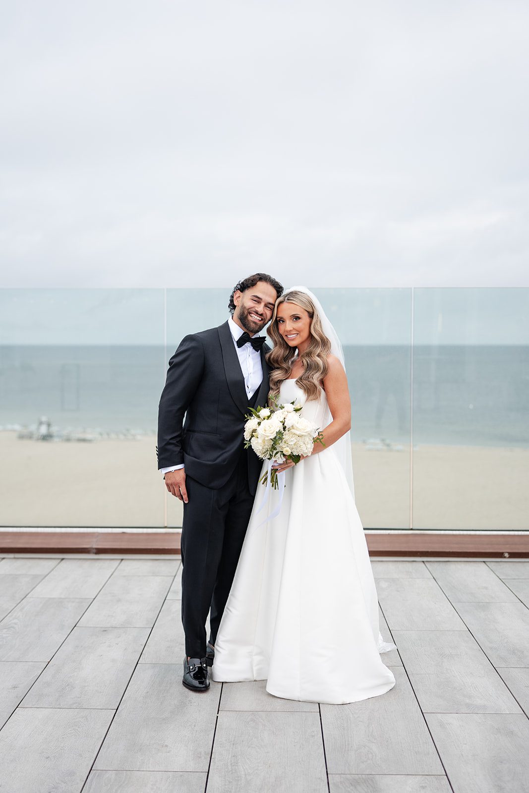 Bride and groom on the deck by Nantucket Sound