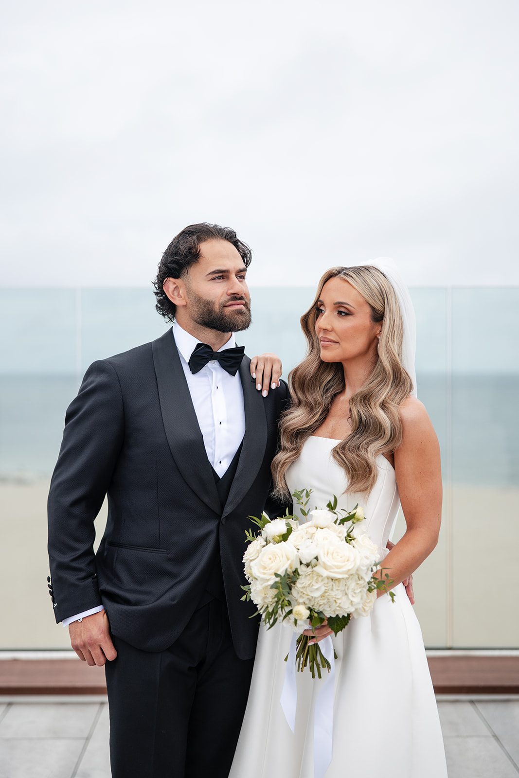 Couple standing together with ocean views, captured by Boston wedding photographers