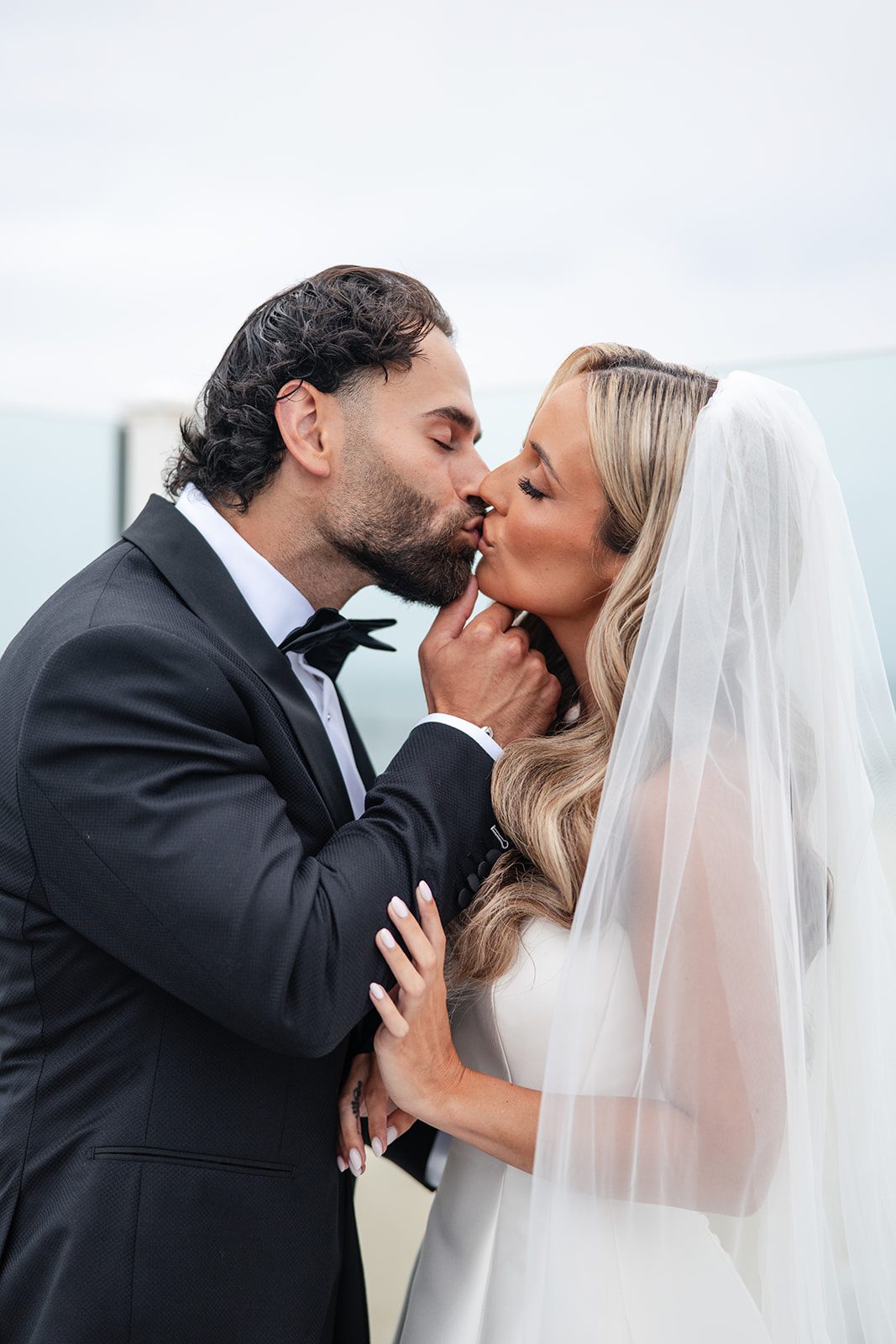 Groom kissing the bride on the cheek