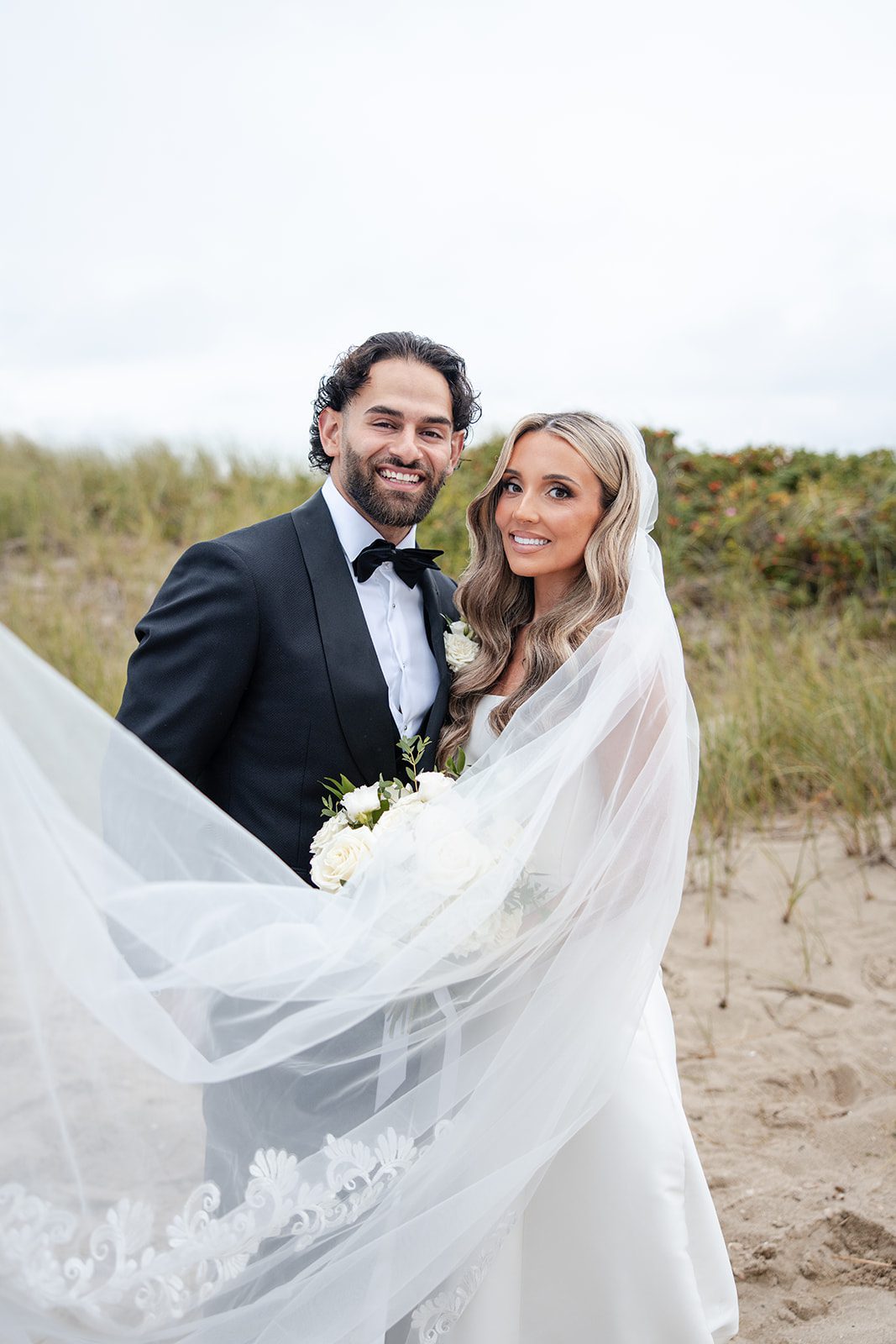 Bride's veil blowing in the beach breeze