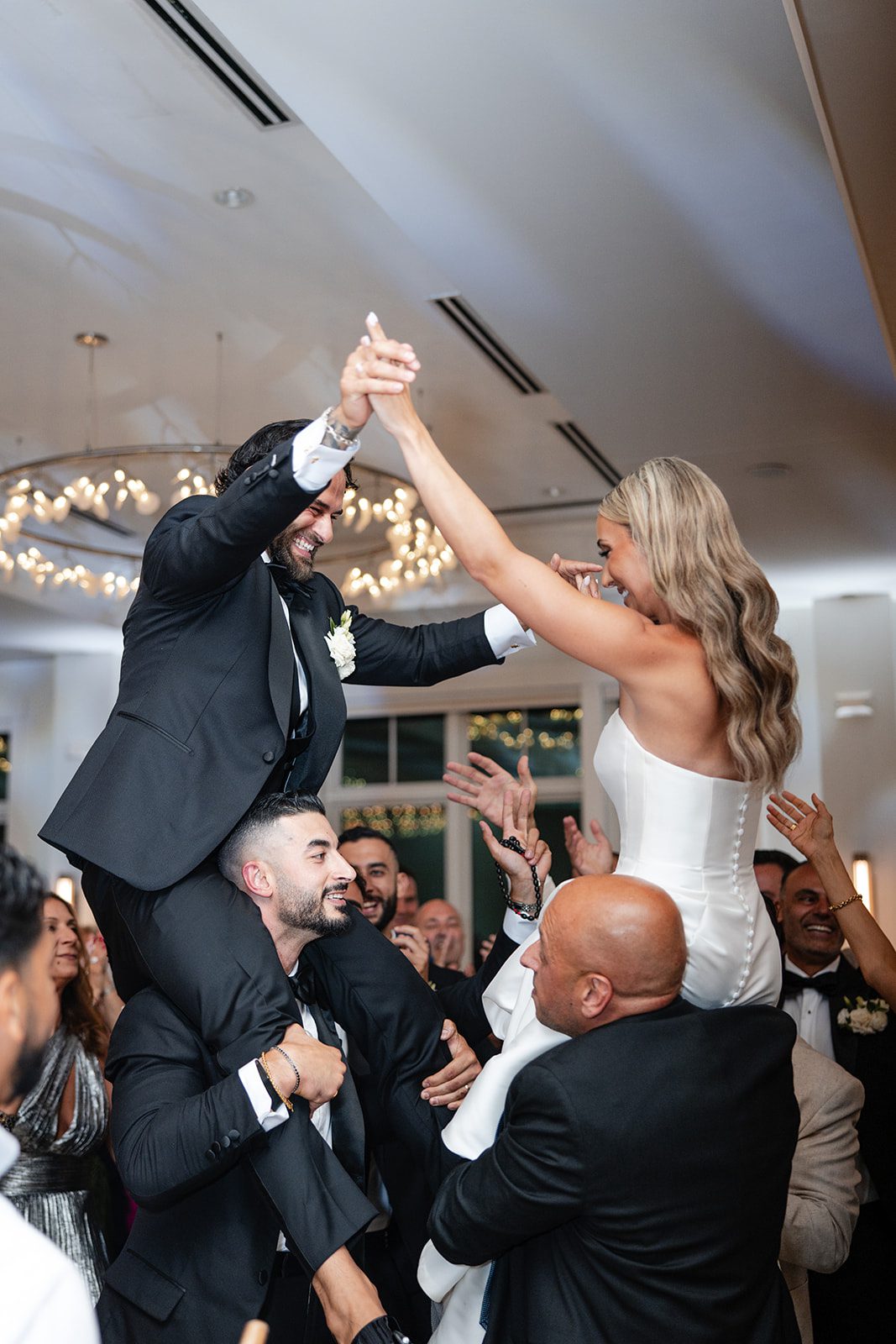 Guests lifting the groom during the entrance