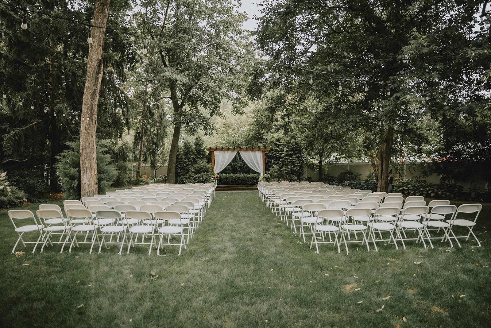 Garden ceremony site with white chairs at The Z Hall