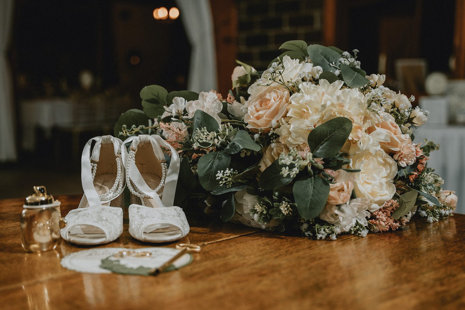 Bridal shoes and bouquet on a table